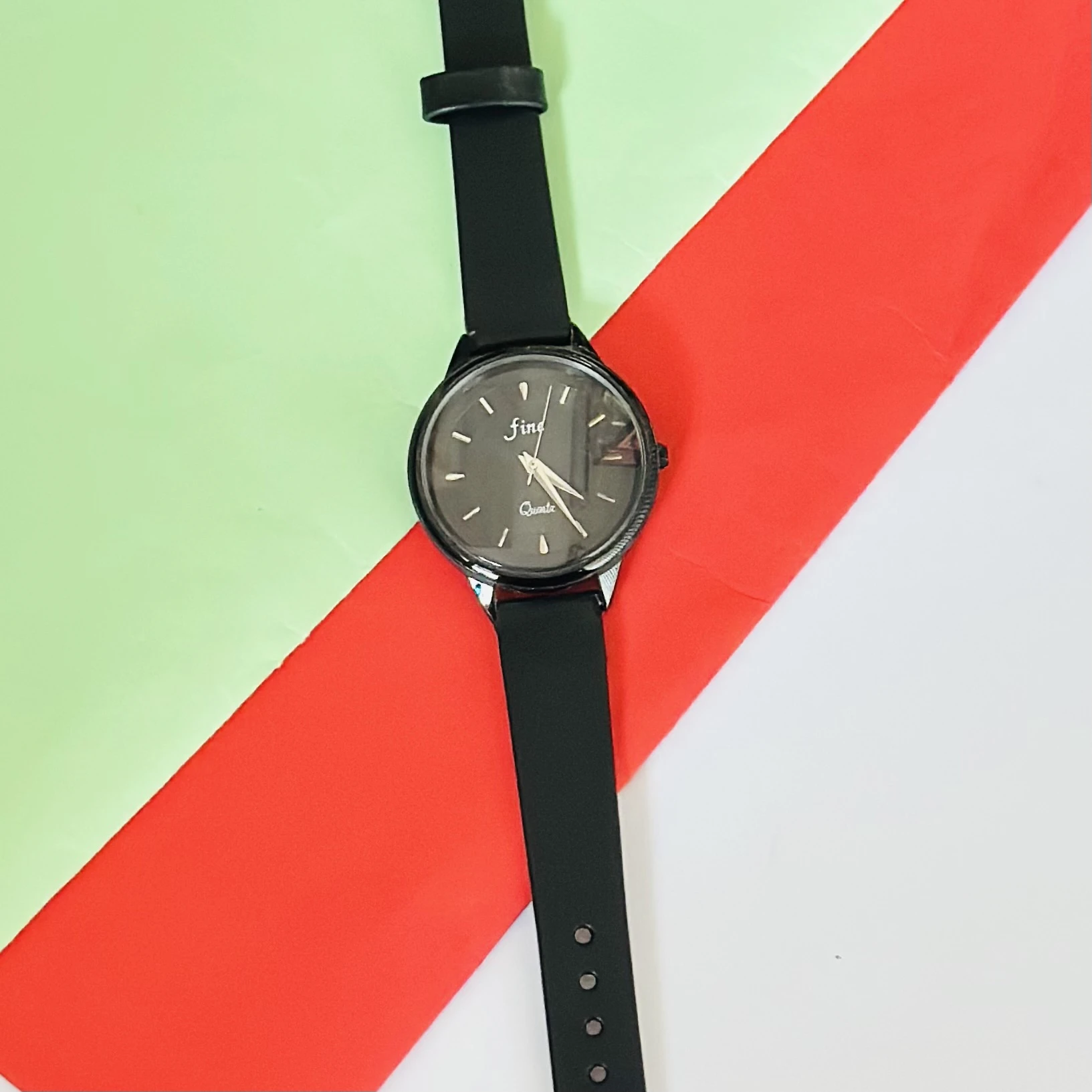 Black analog quartz wrist watch with a black strap.