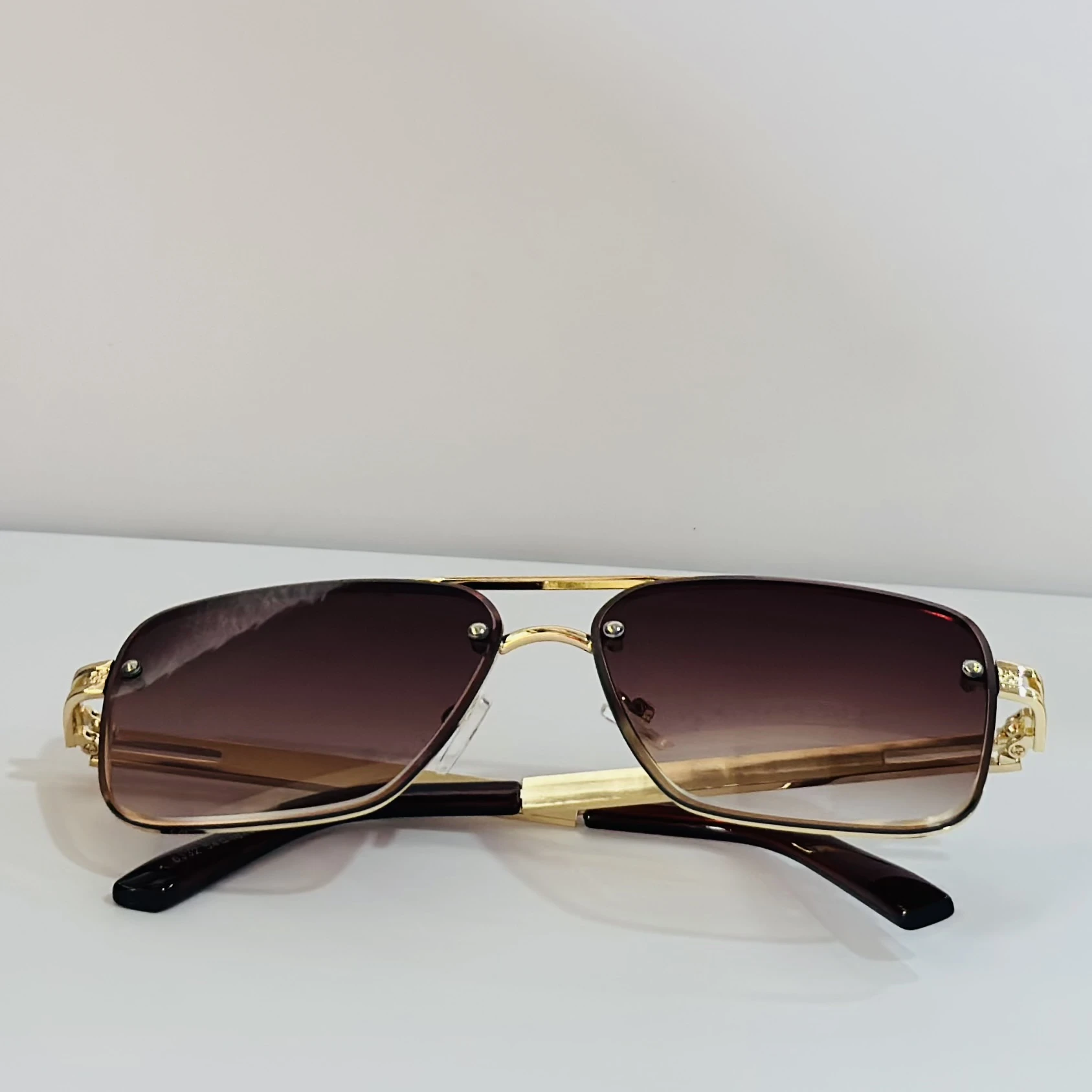 pair of Maybach aviator sunglasses with a gold-tone frame and brown gradient lenses
