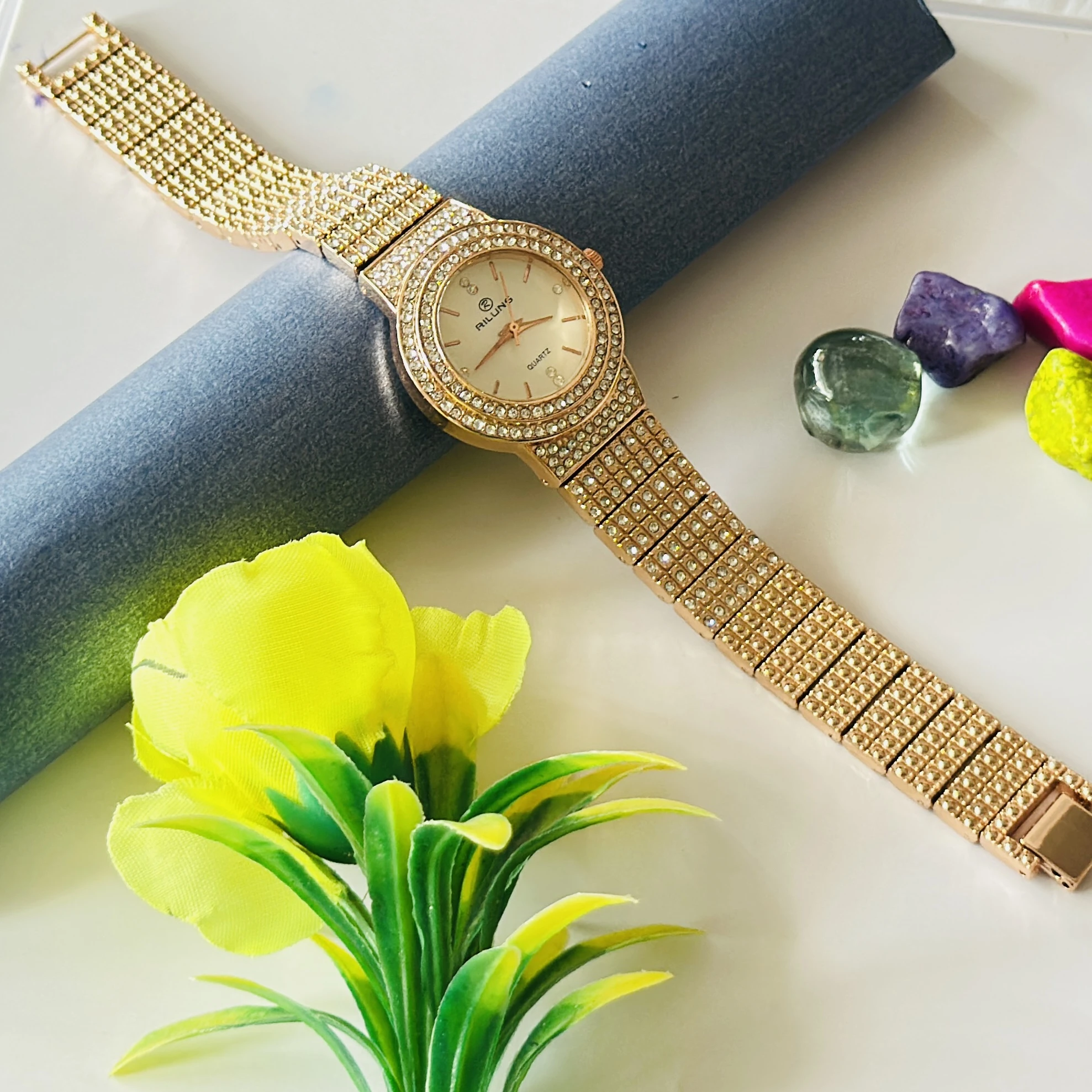 Gold toned Riluns analog quartz watch embellished with rhinestones