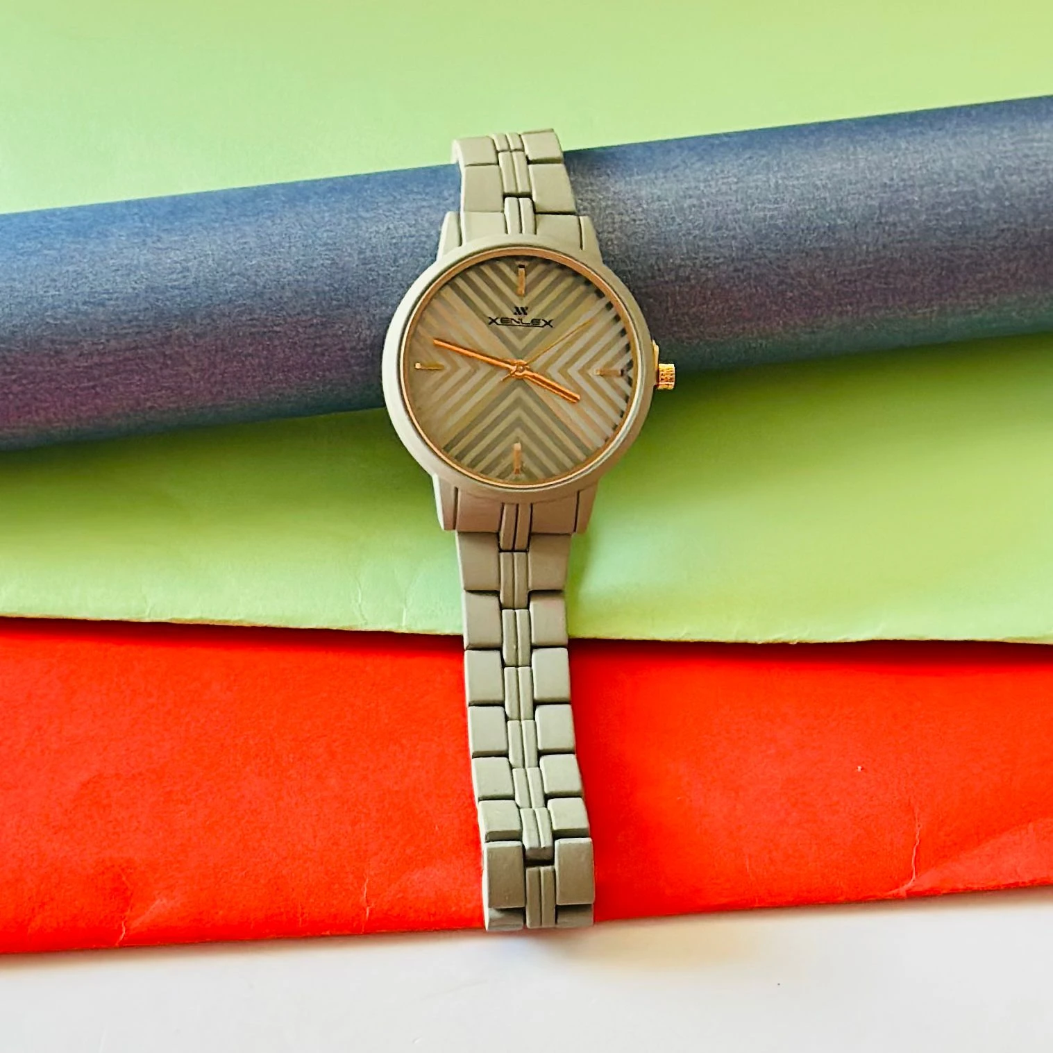 bright magenta or white  analog watch with a matching link bracelet.