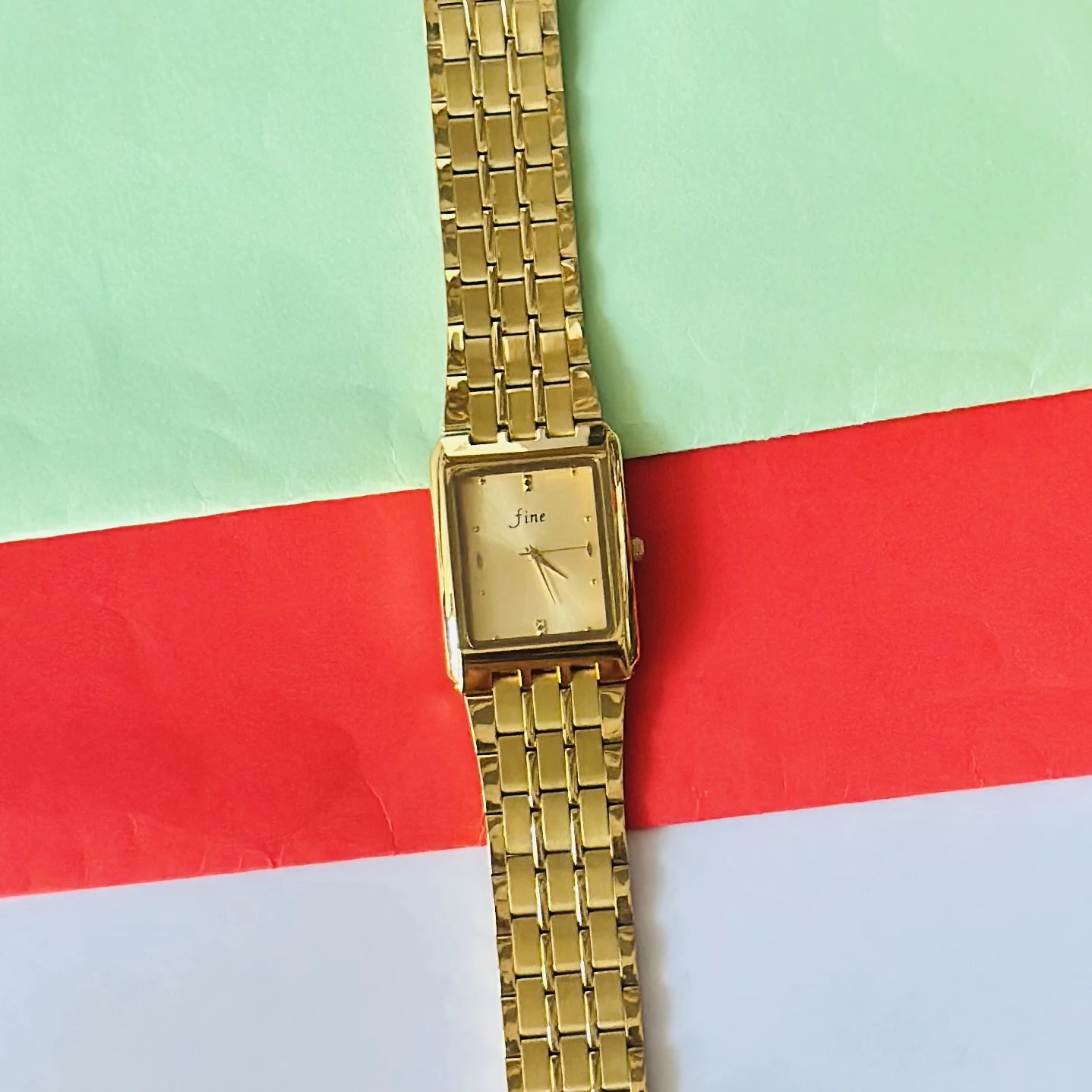 Gold -tone analog quartz watch with a metal strap.