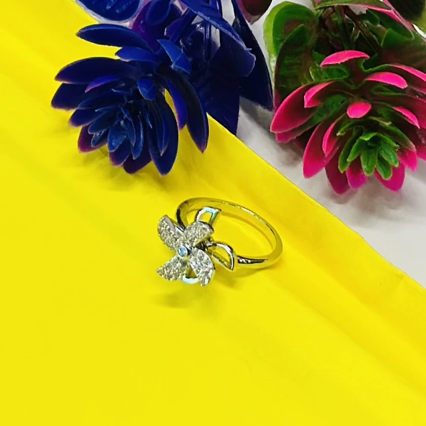 silver floral-shaped ring adorned with sparkling cubic zirconia or diamonds.