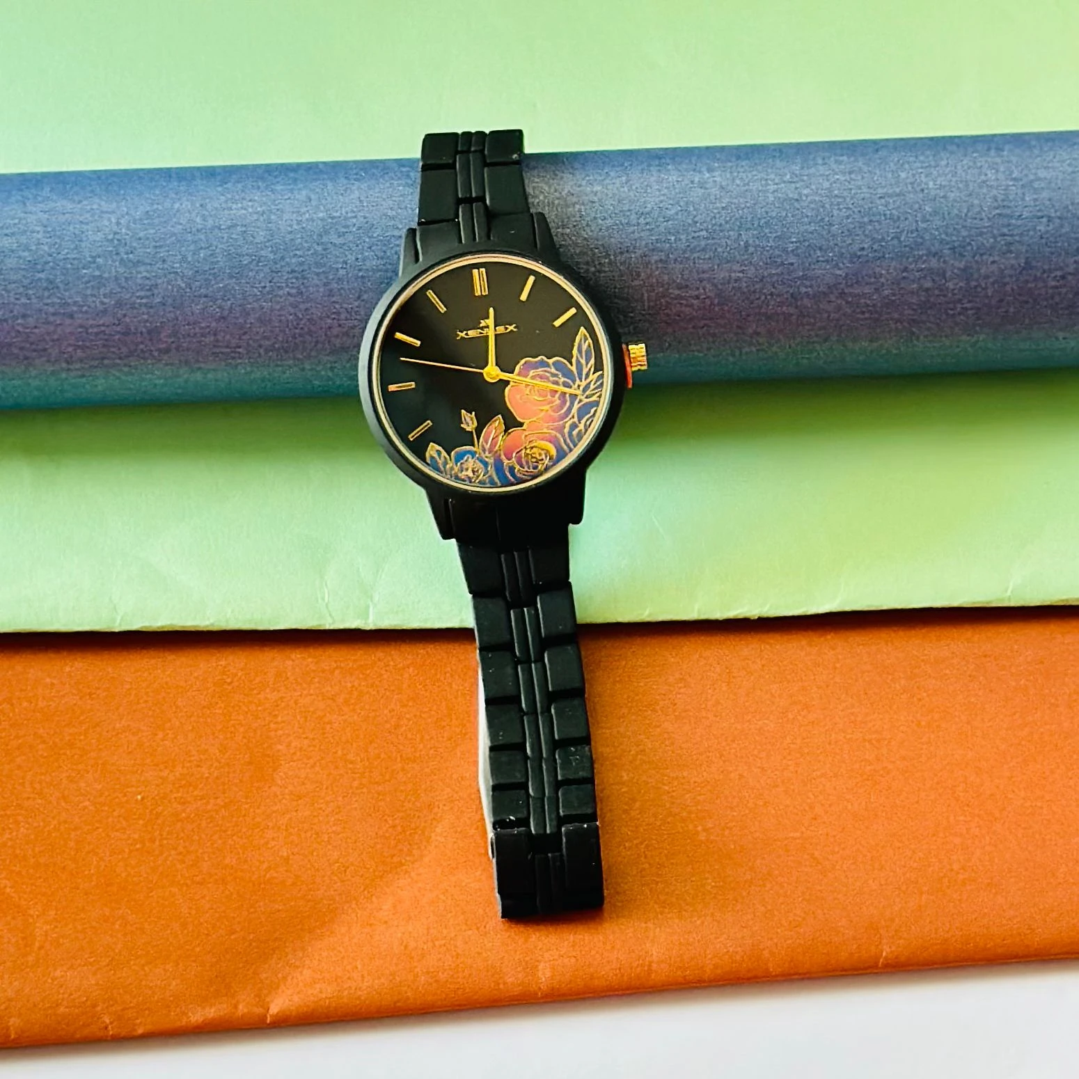black metal analogue watch with a floral dial design