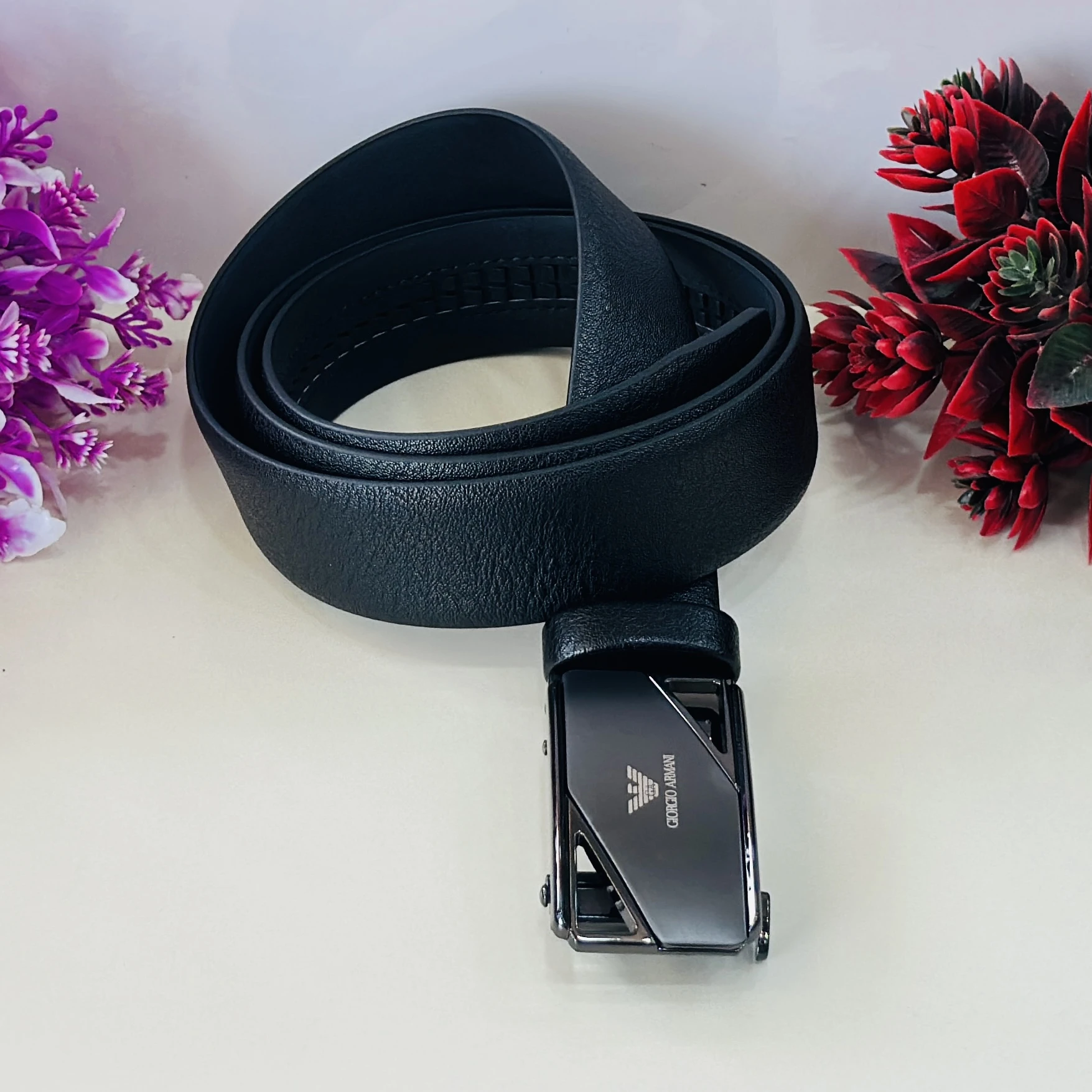 Giorgio Armani black leather ratchet belt with a metal logo buckle.