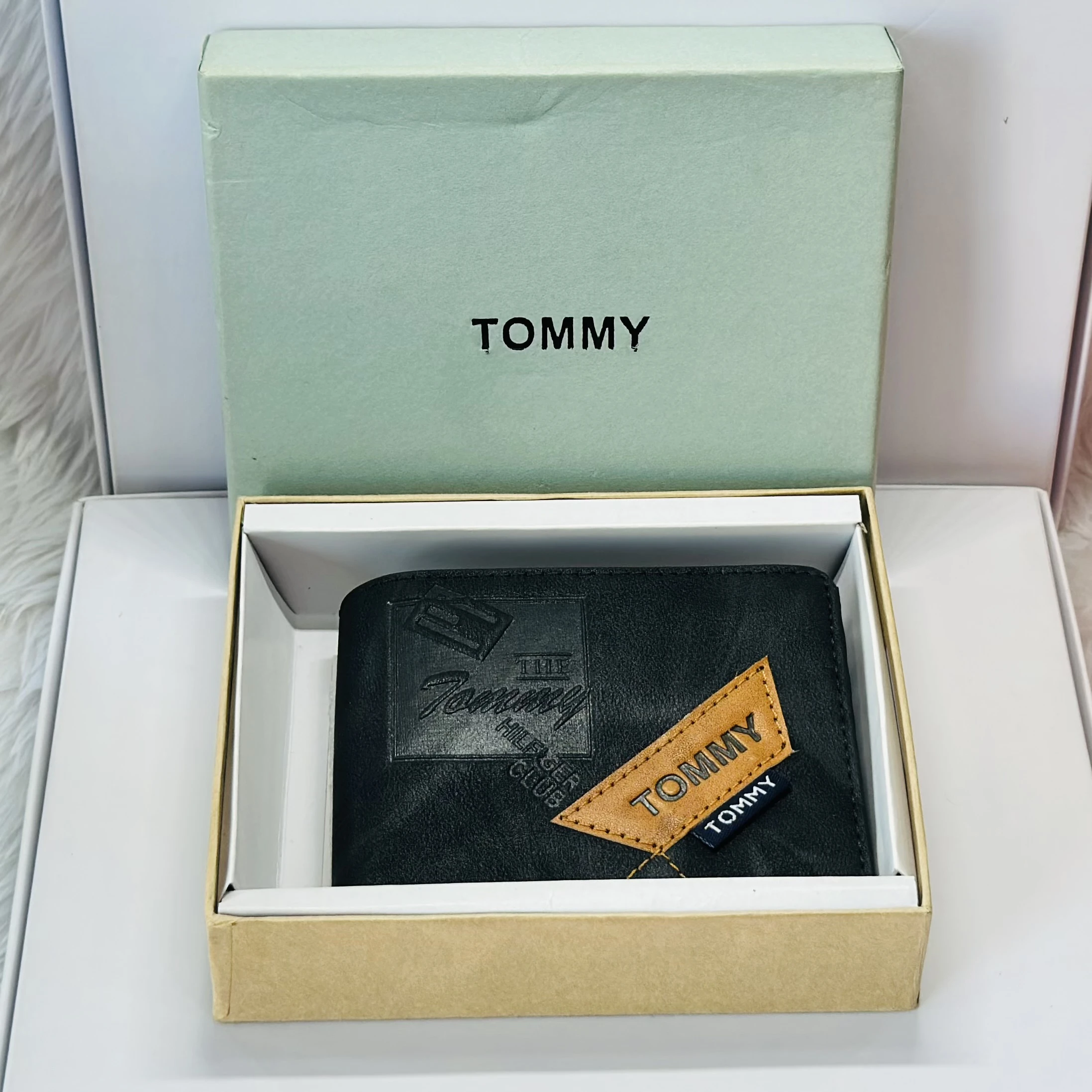 Tommy Hilfiger men's black leather bi-fold wallet.