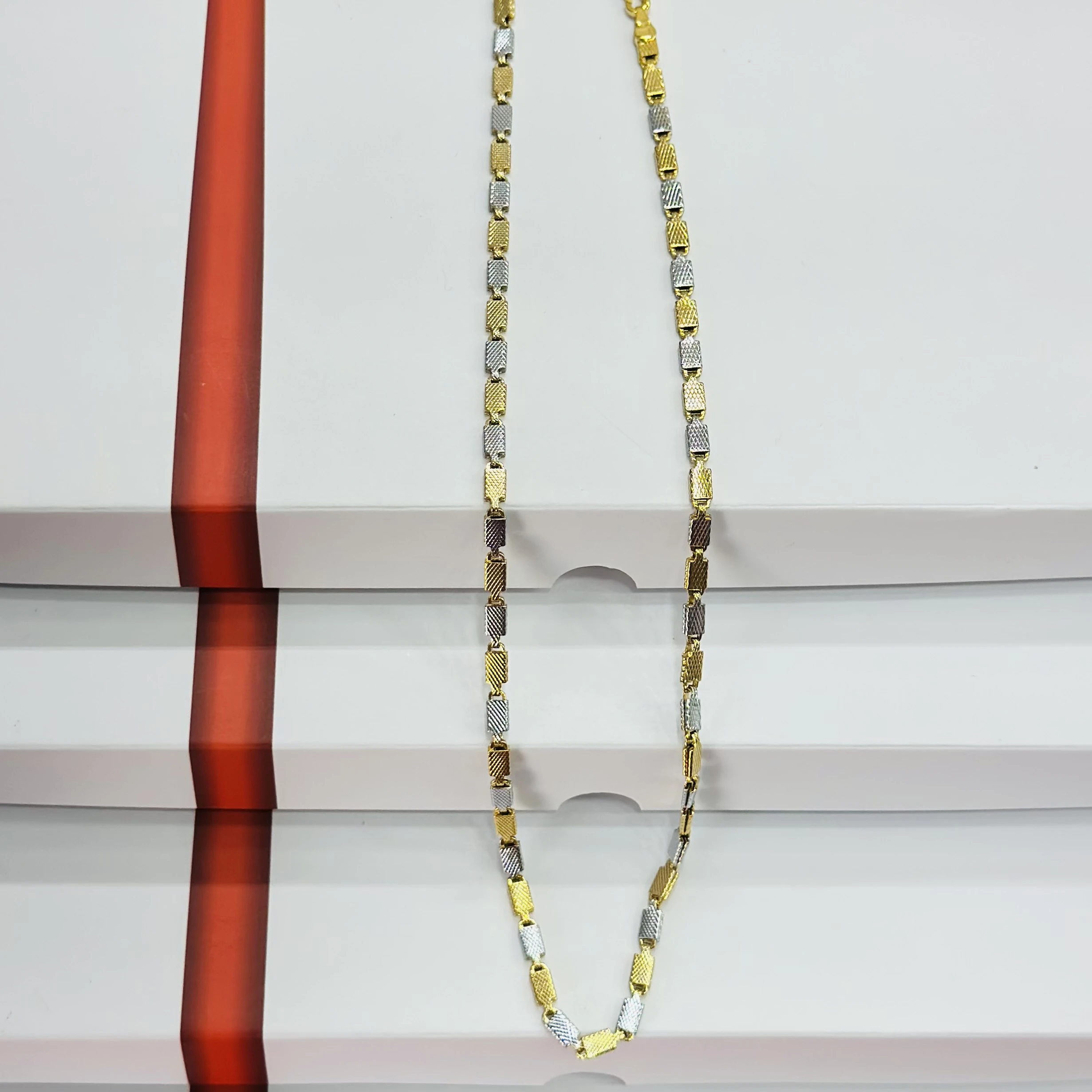 Two tone silver and golden-colored stainless steel chain