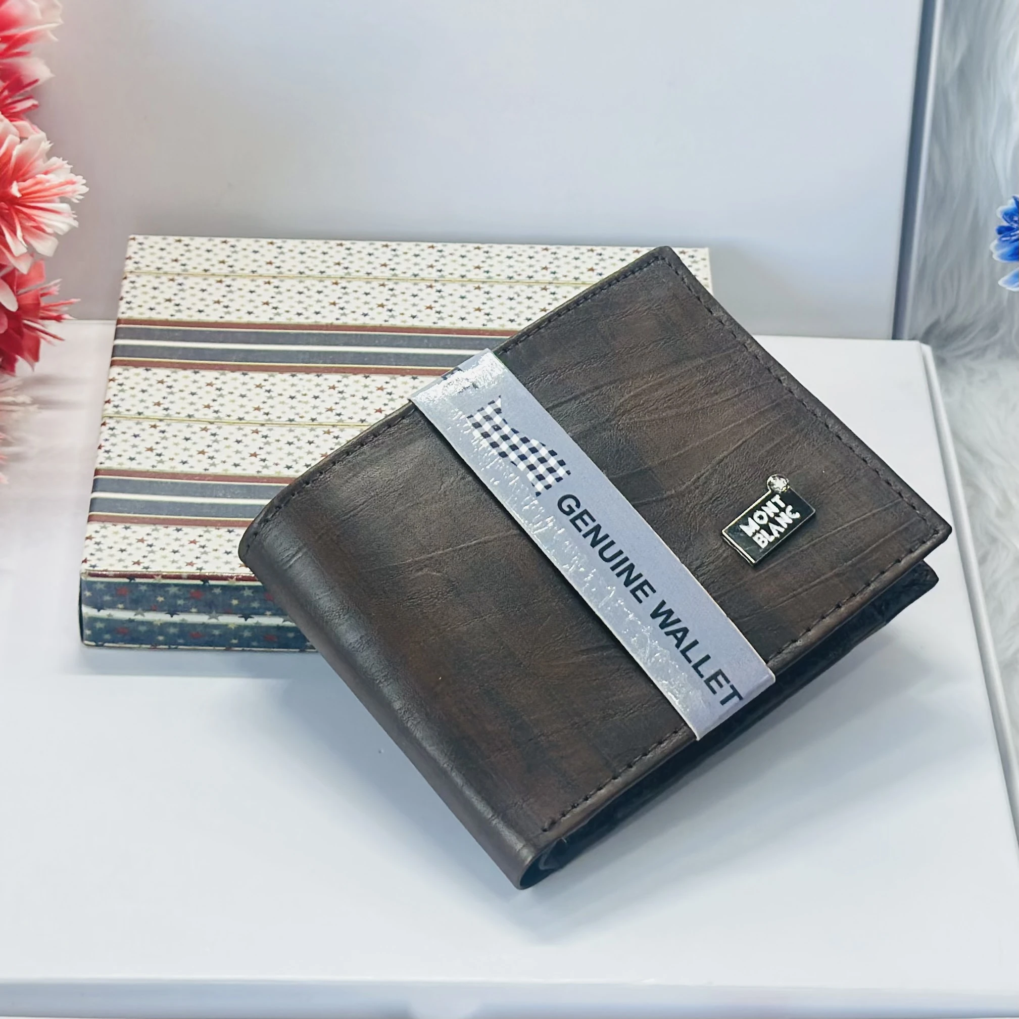 a brown bifold wallet, possibly made of genuine leather, branded as a Montblanc product.