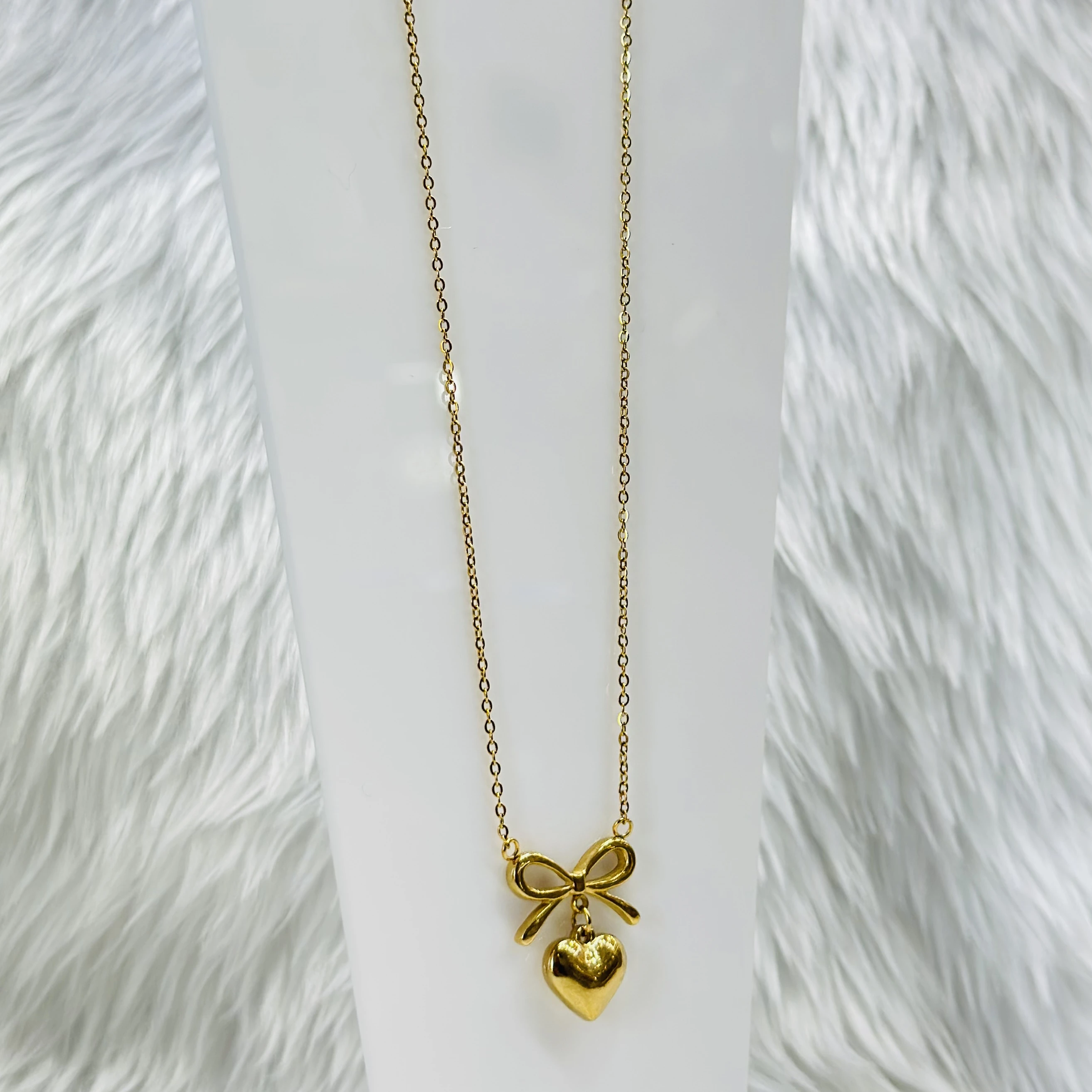Gold plated stainless steel anti-tarnish necklace with a bow and heart pendant