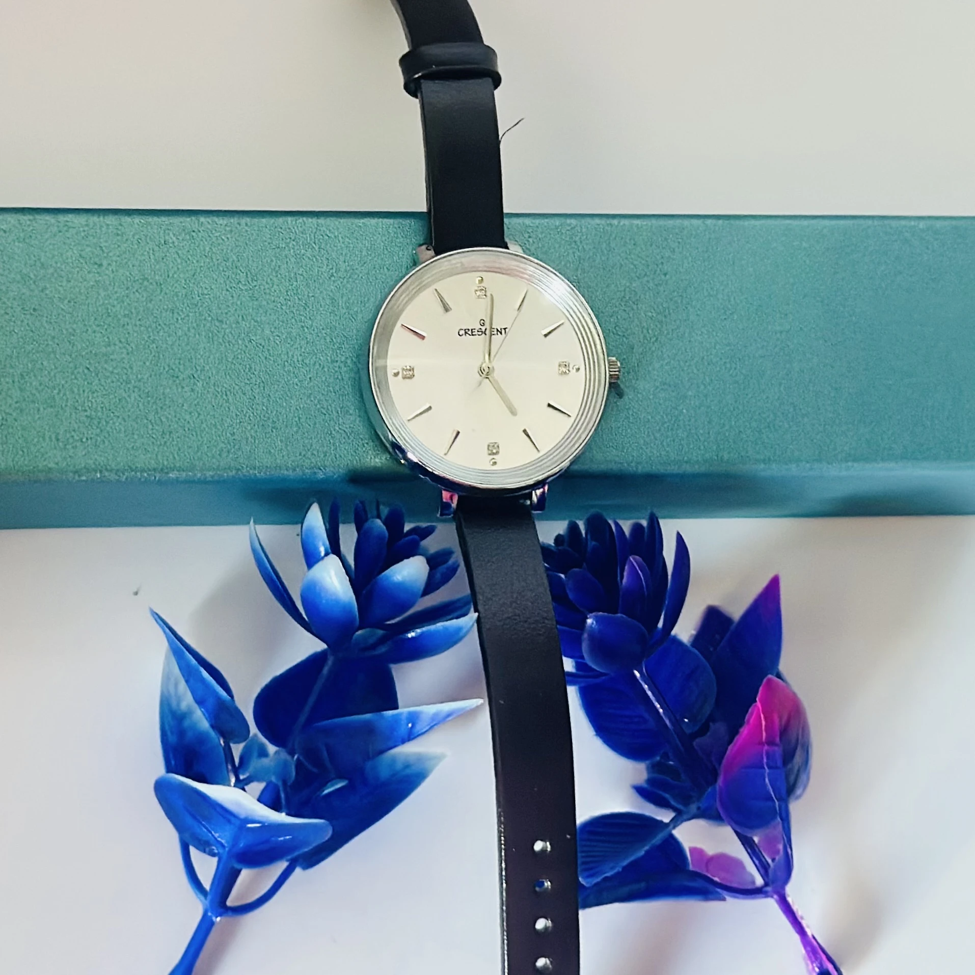 watch with a black leather band.