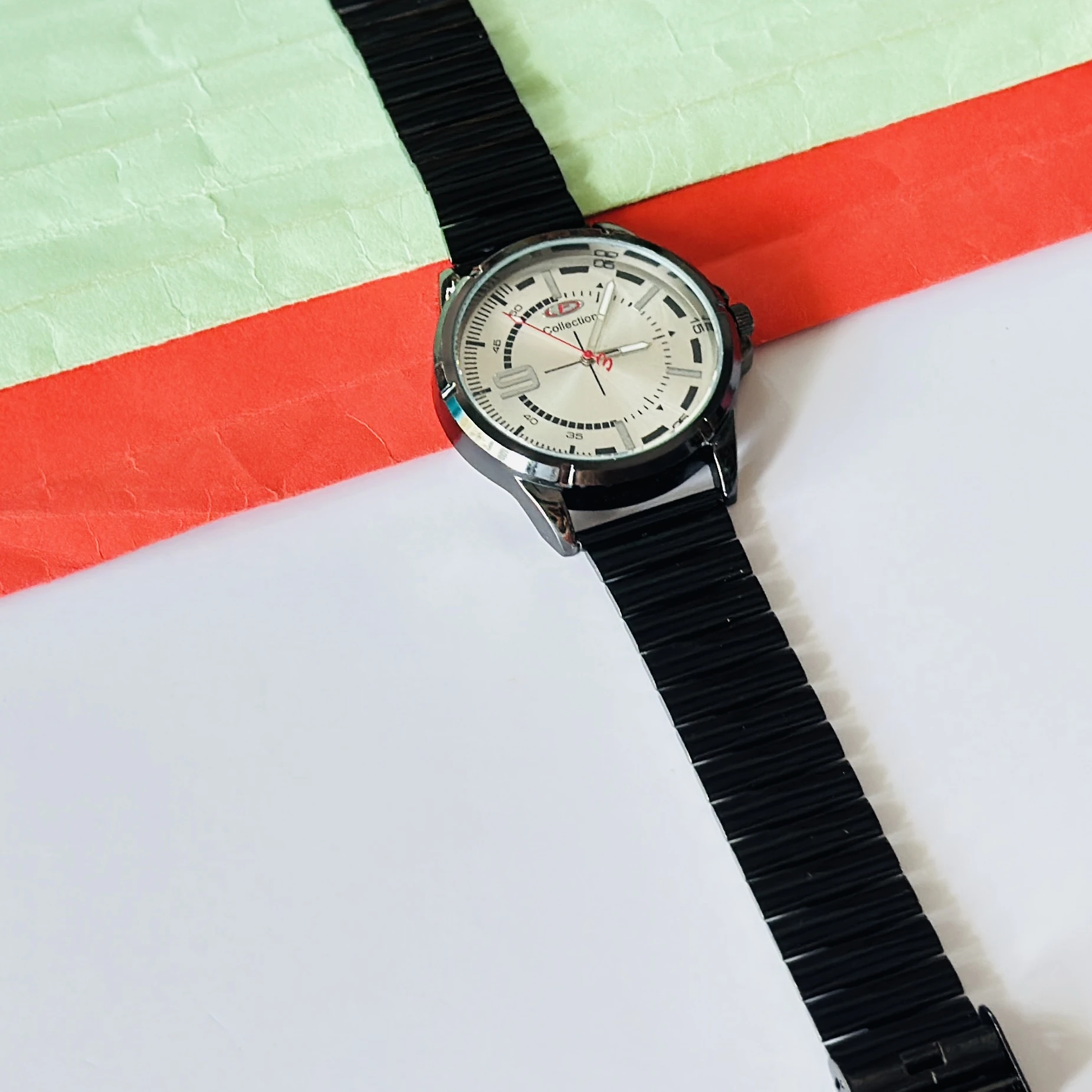 silver-toned dial and a black metal strap