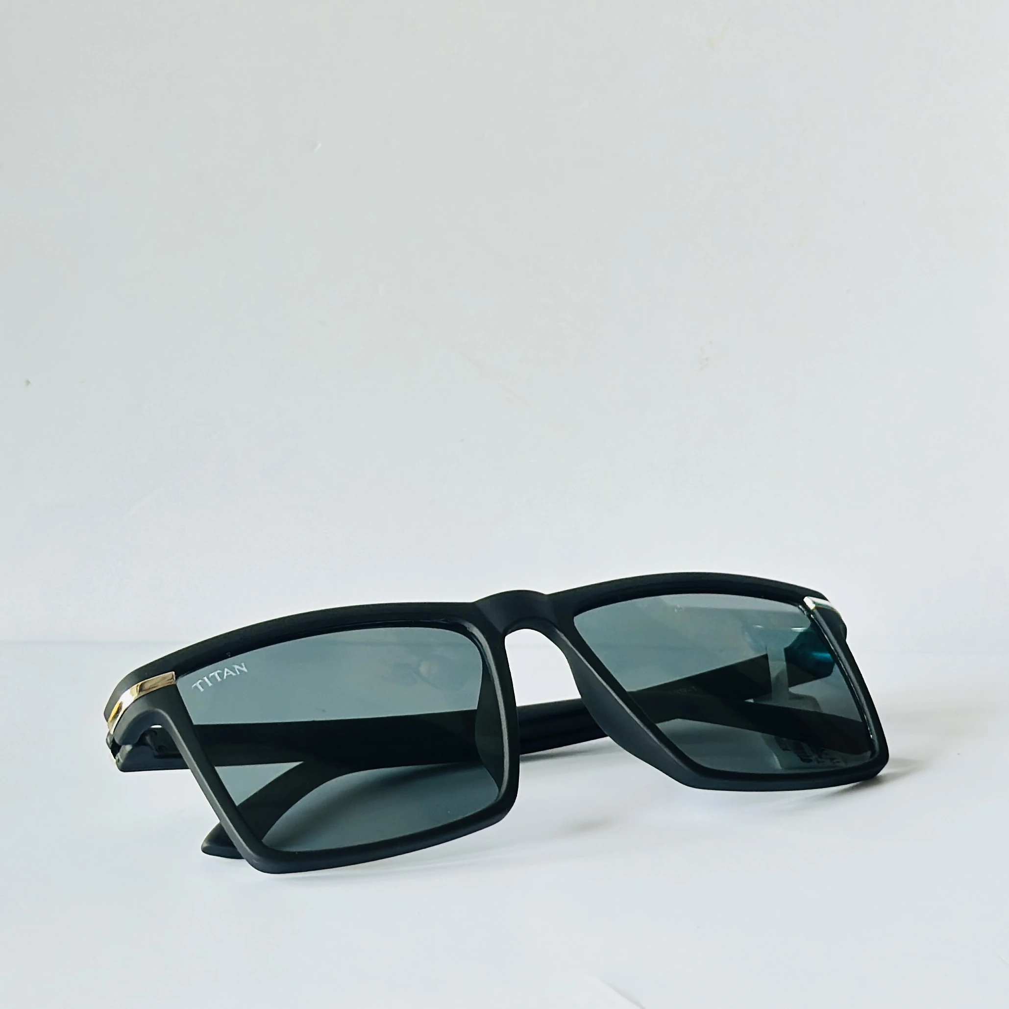 Black rectangular frame with blue-toned lenses.