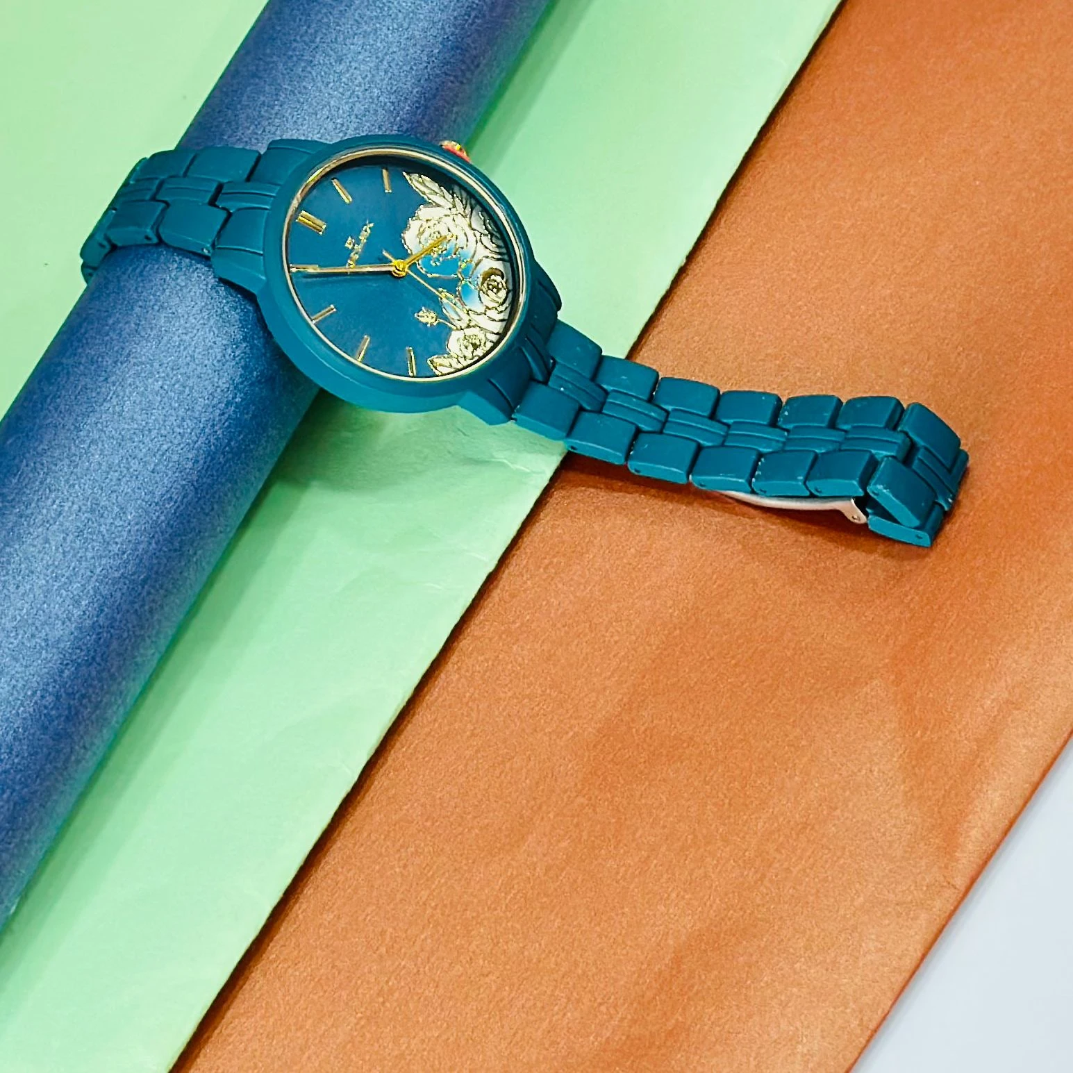 TEAL BY CHUMBAK Tulip Garden Quilted Analog Watch for Women in a teal blue hue.
