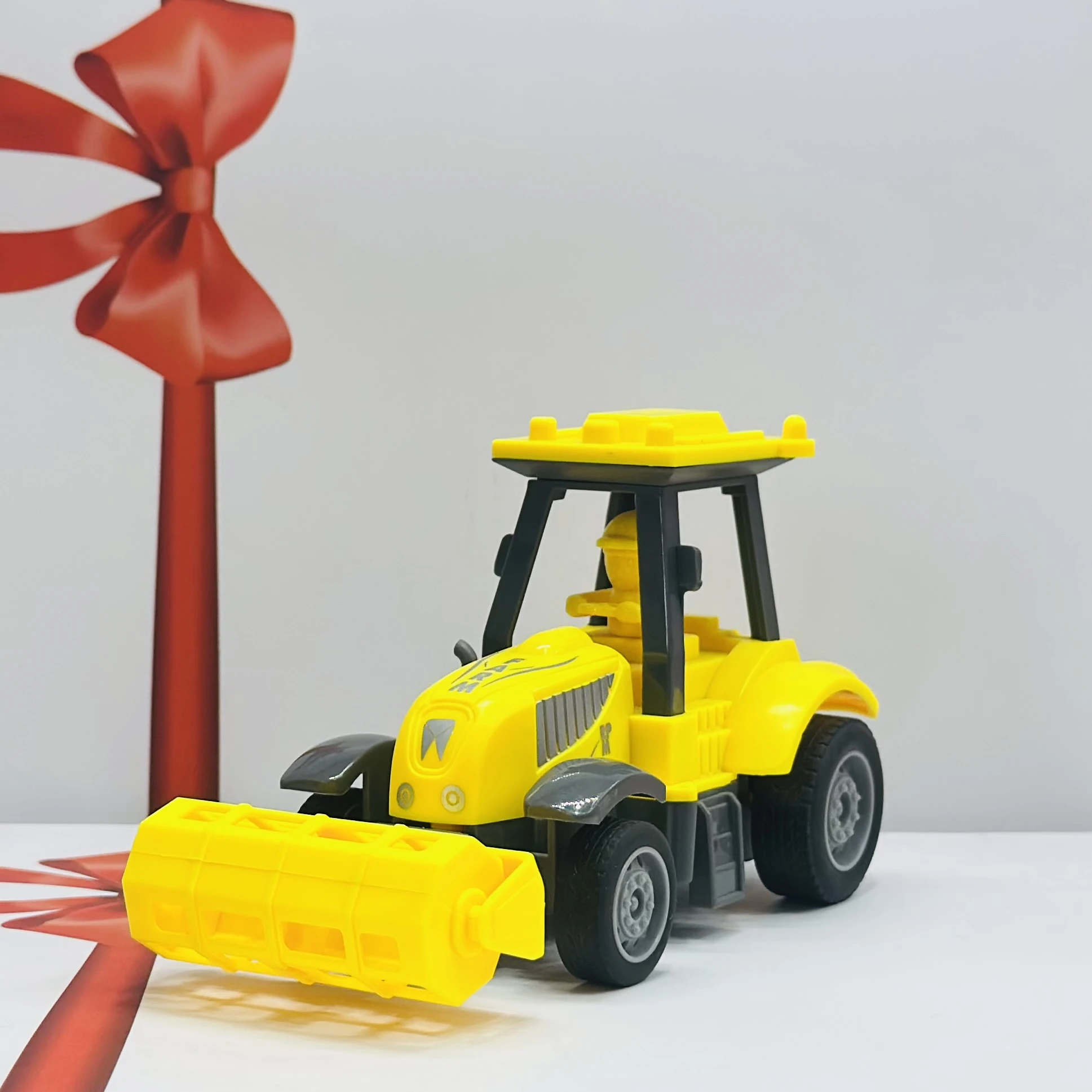 Yellow plastic toy tractor