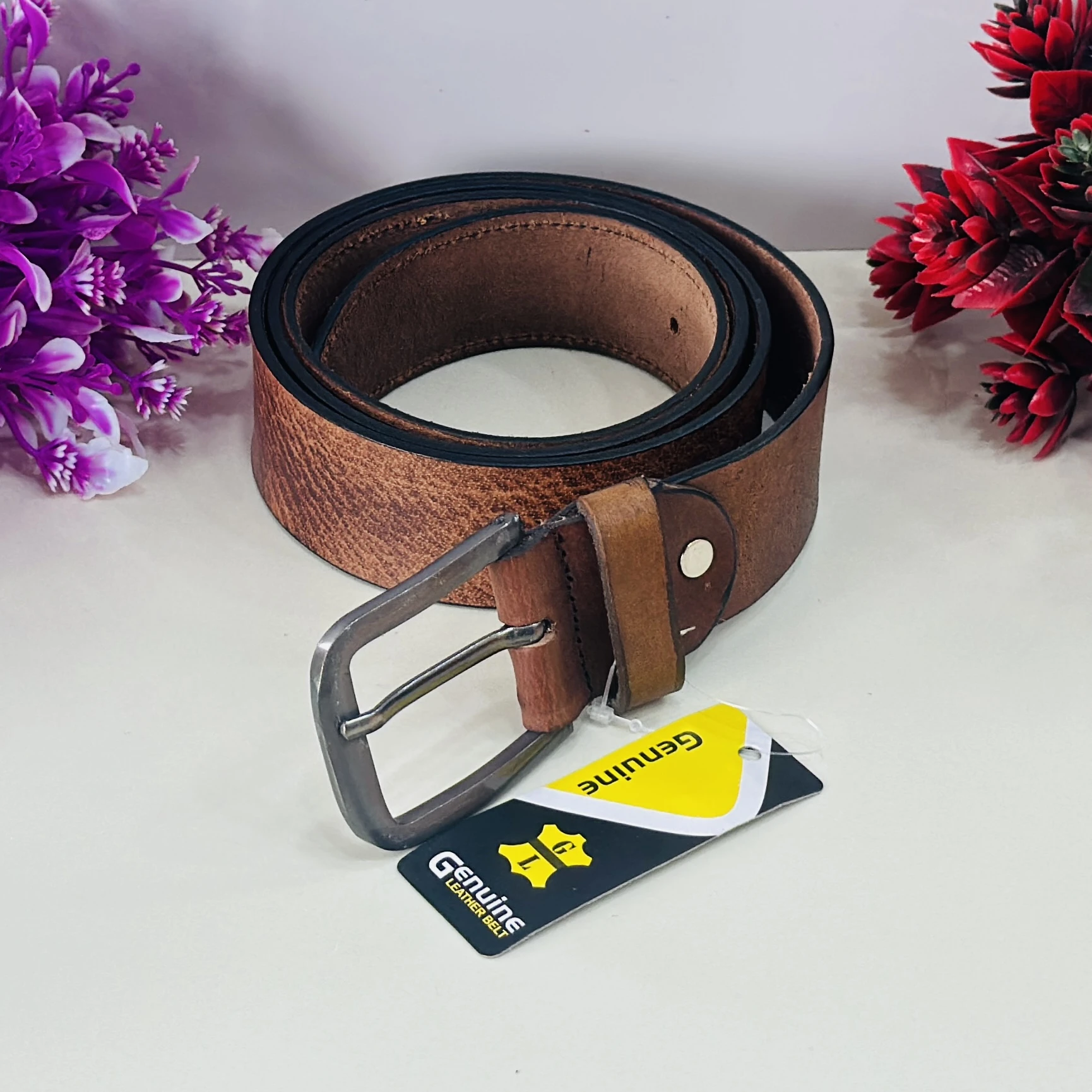 brown genuine leather belt with a pin buckle closure.