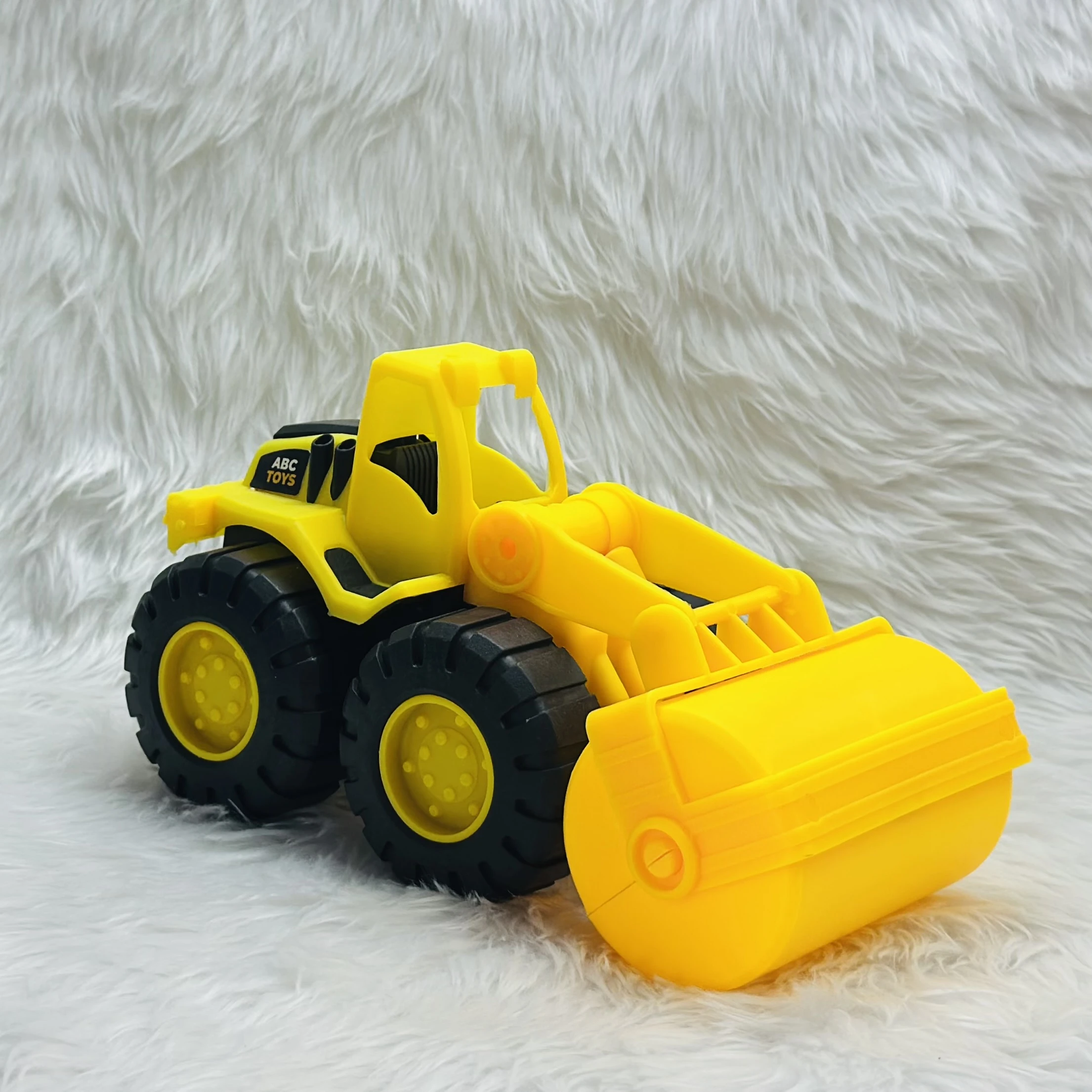 yellow toy construction vehicle, identified as a bulldozer or wheel loader,