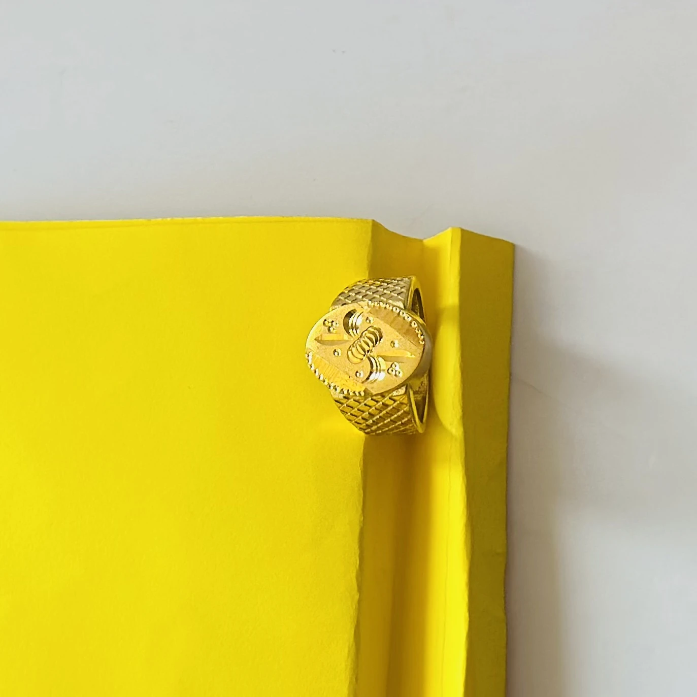 22kt yellow gold men's ring with a matte finish and machine-cut designs.