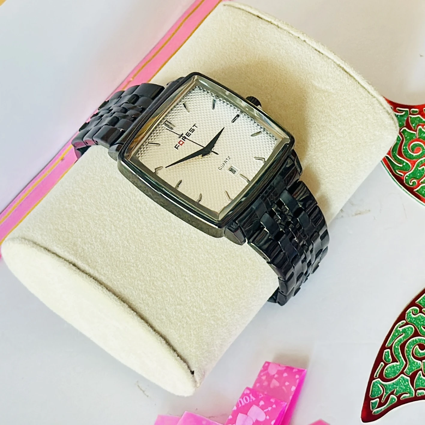 premium square-look timepiece featuring a black chain strap and a white dial.