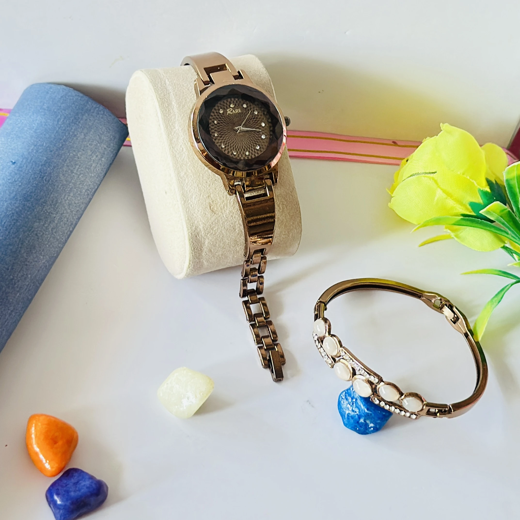 Rose gold-tone ladies wristwatch with a crystal-embellished round dial and bracelet strap.