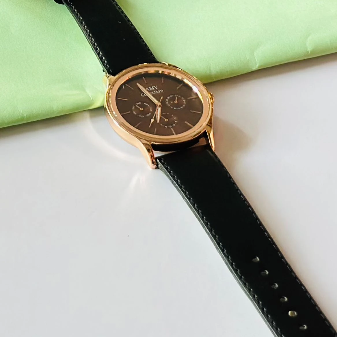 Round  analog watch with a black  leather strap