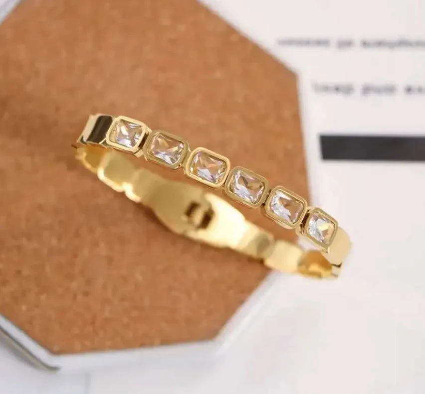 Gold tone hinged bangle bracelet