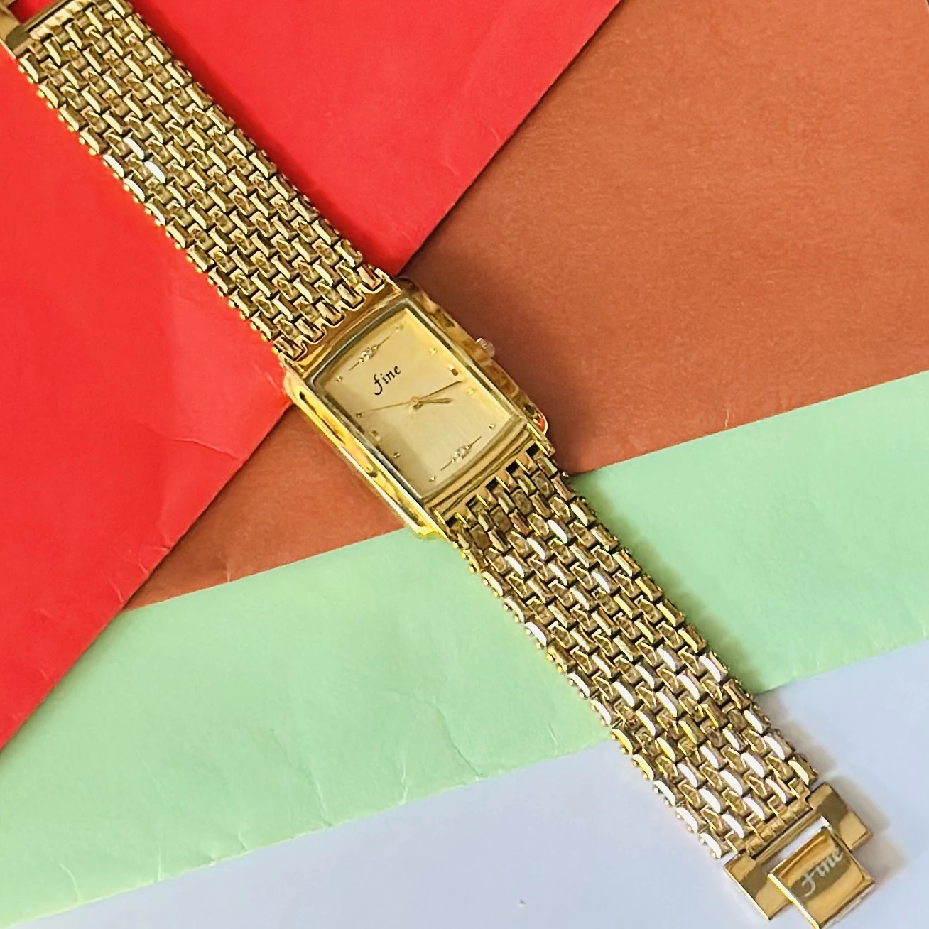 Gold -tone analog quartz watch with a metal strap.