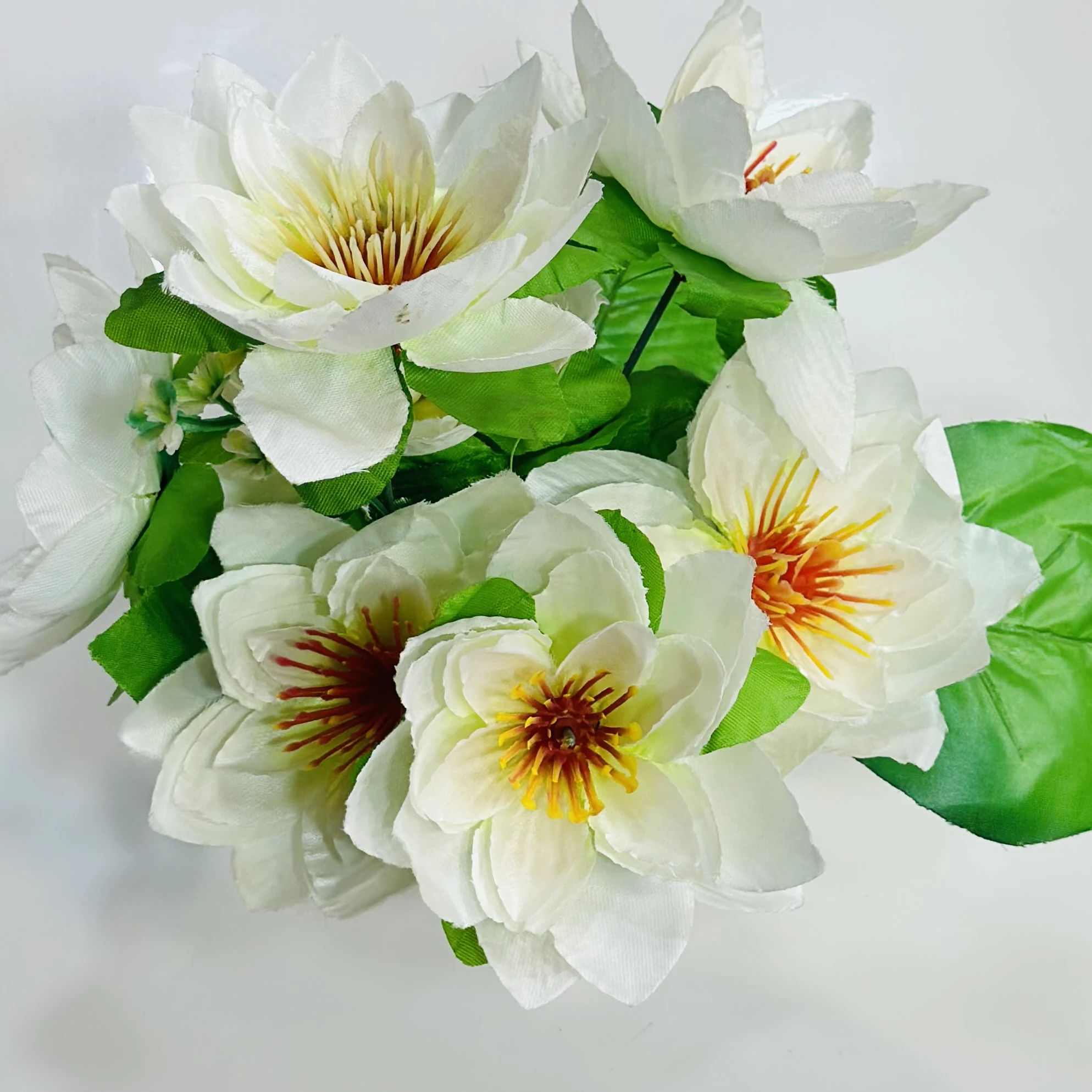 Flower arrangement in a white ceramic pot.