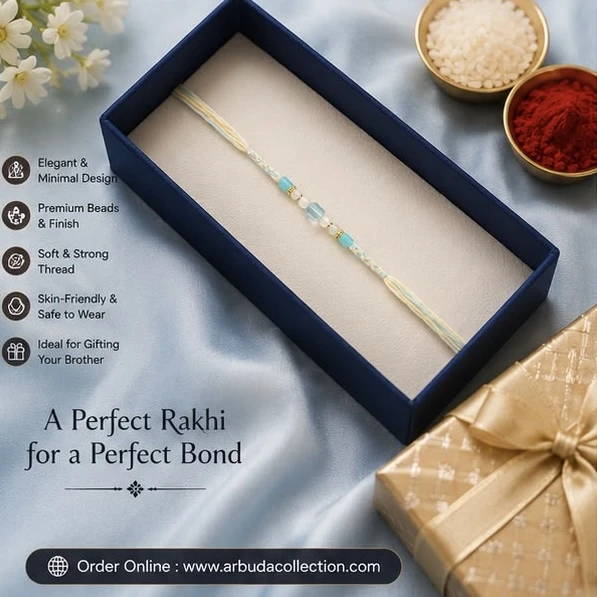 handmade, minimal beaded Rakhi featuring blue and cream braided cotton thread and glass beads.