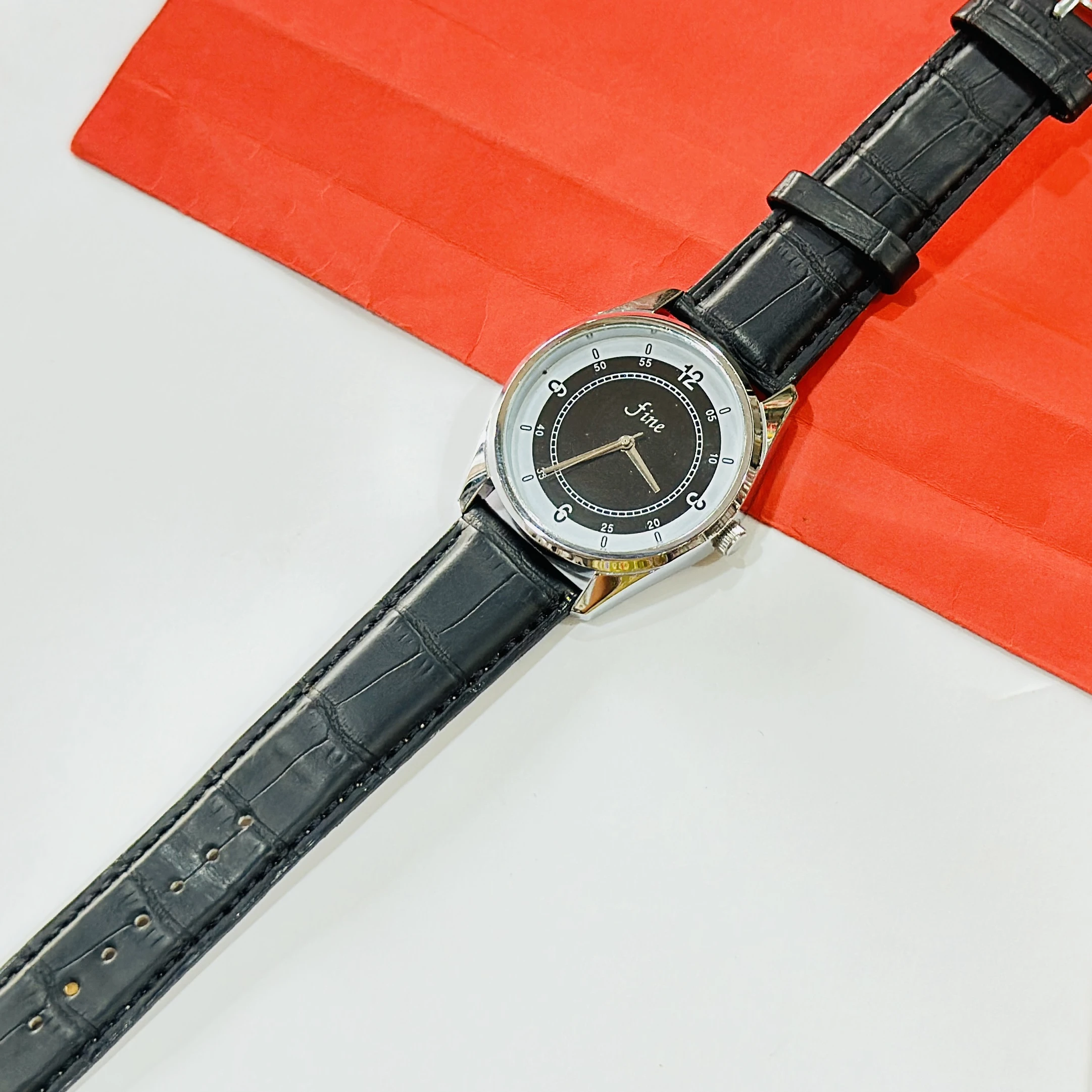 wrist watch with a black leather band and a silver-toned case.