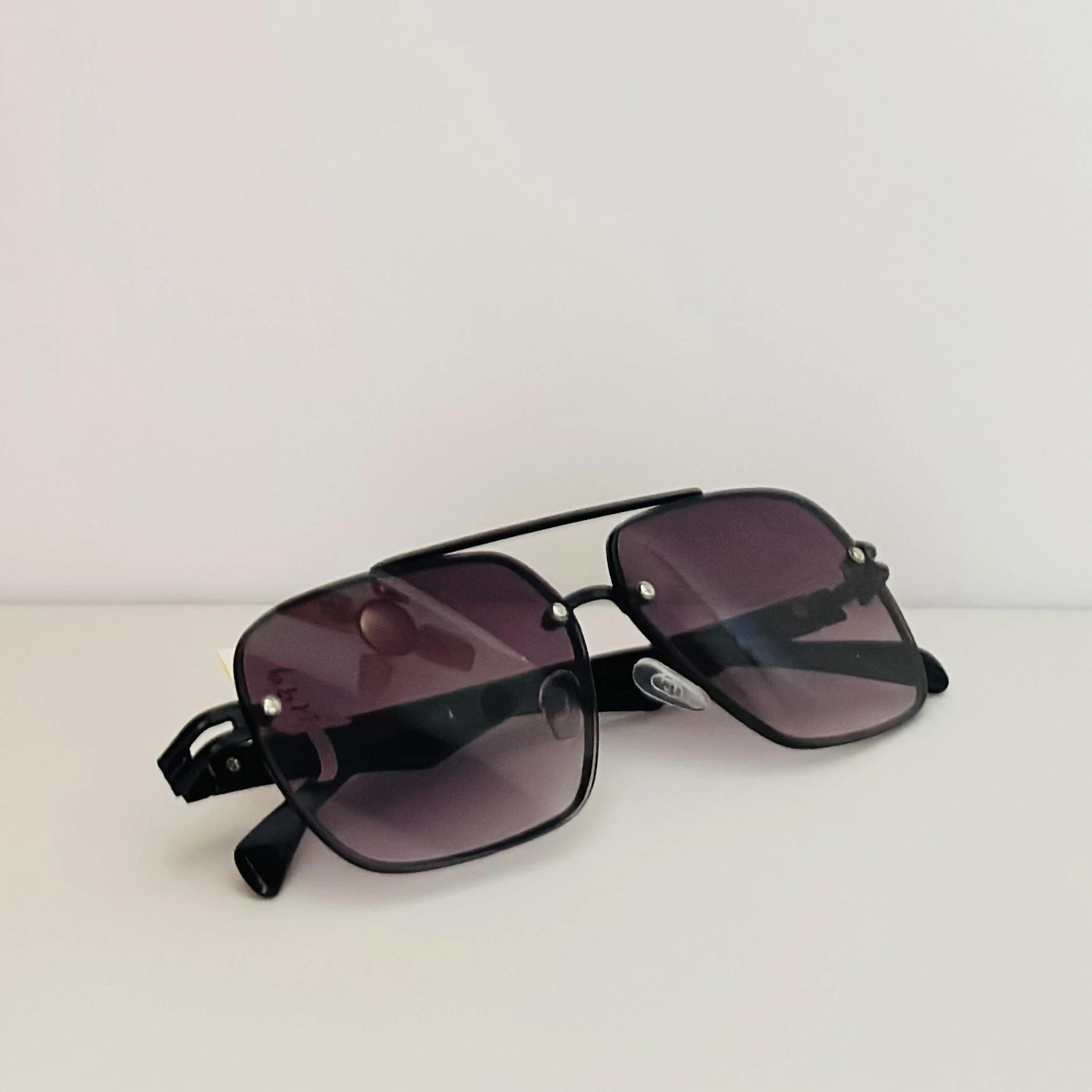 gradient square sunglasses with a black frame.