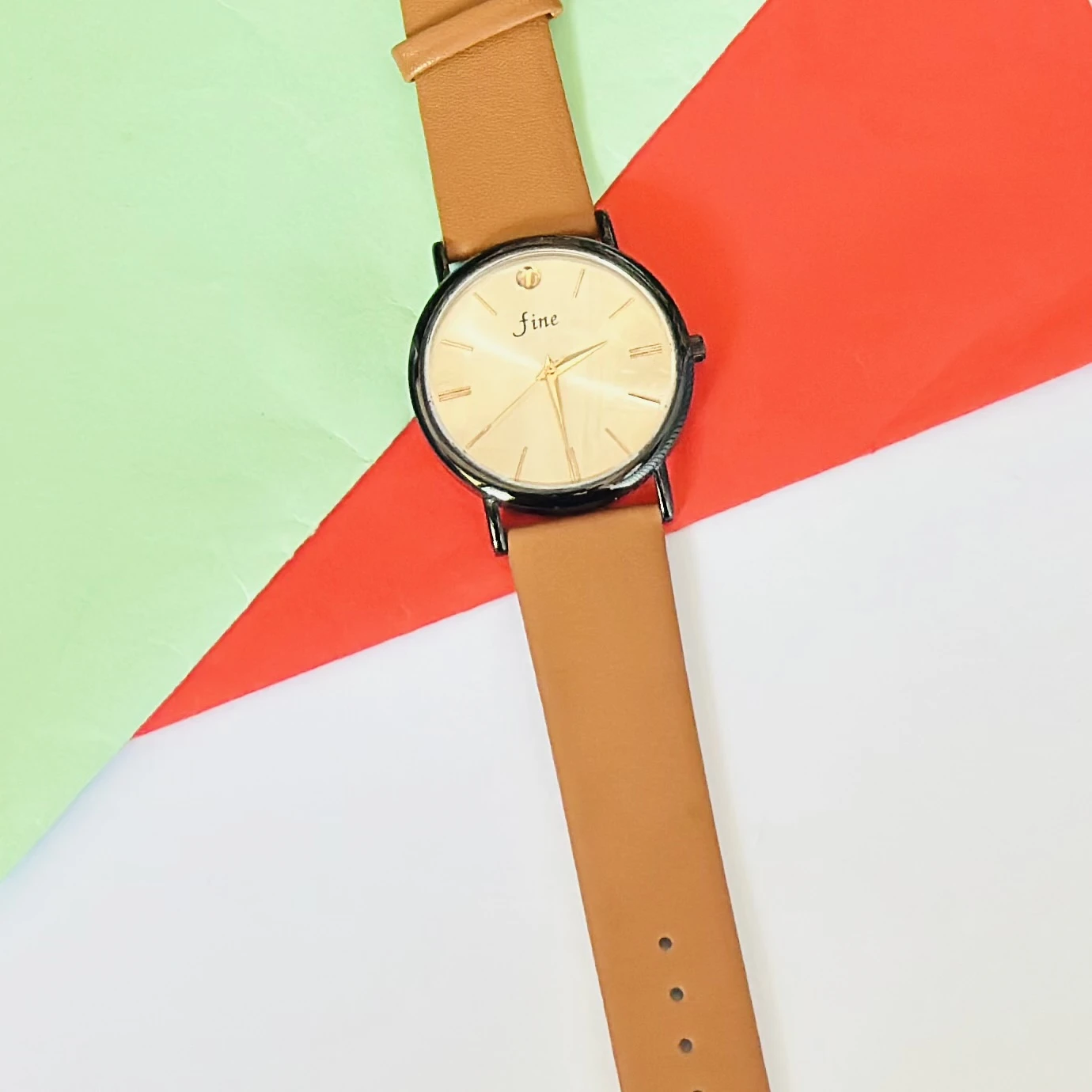 Analog wristwatch with a gold-tone case and a brown leather strap.