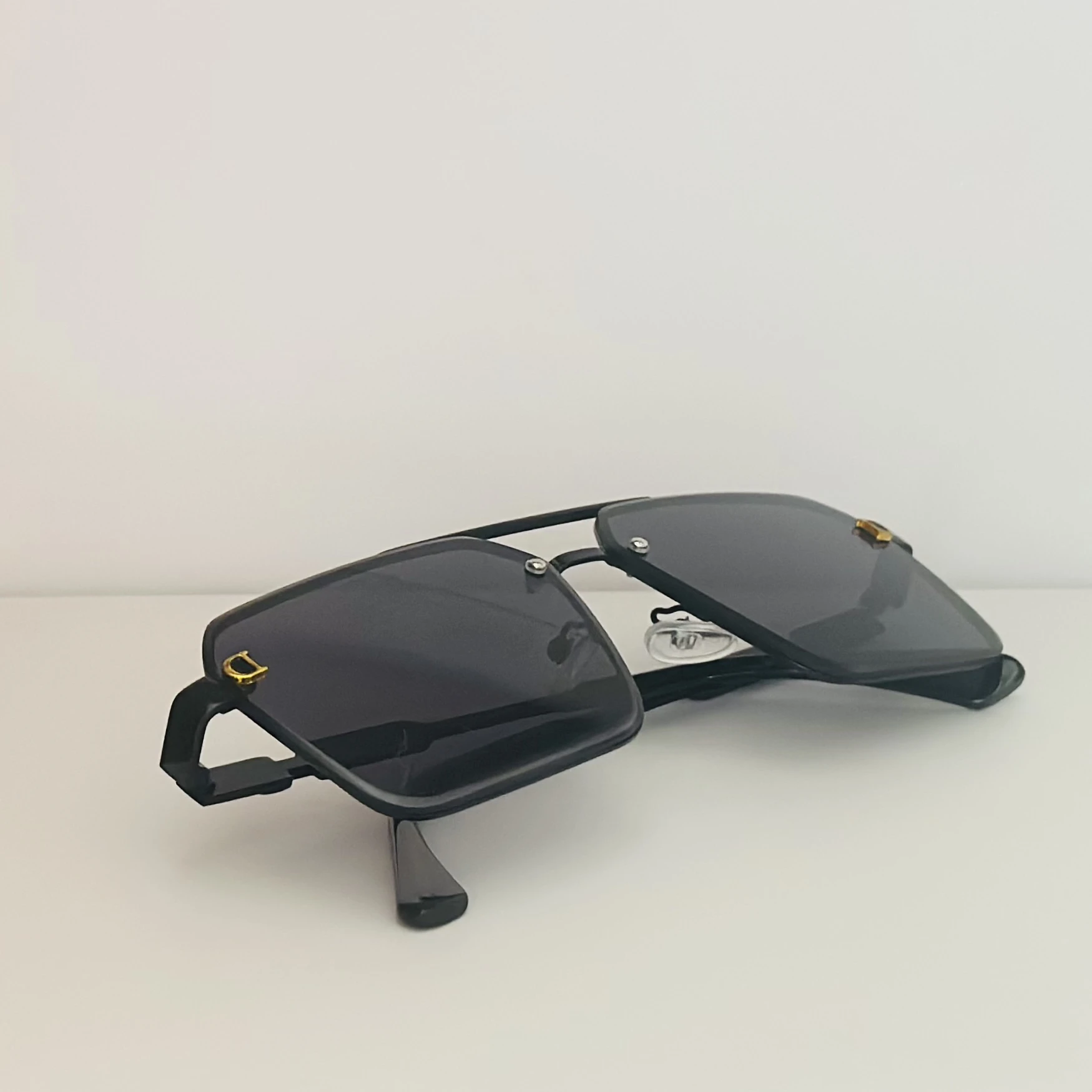 black pilot-style sunglasses with grey polycarbonate lenses.