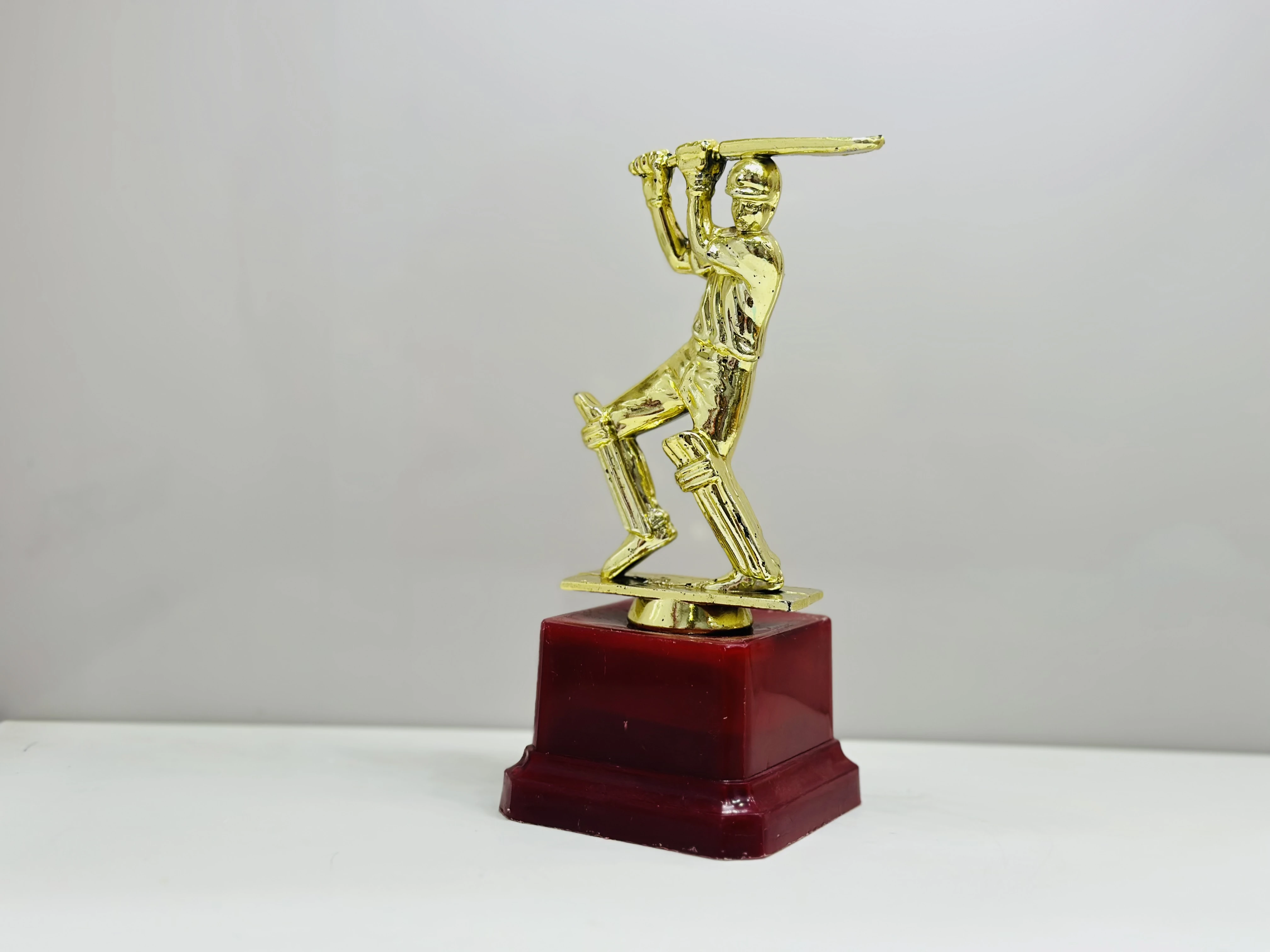cricket trophy featuring a batsman figure.