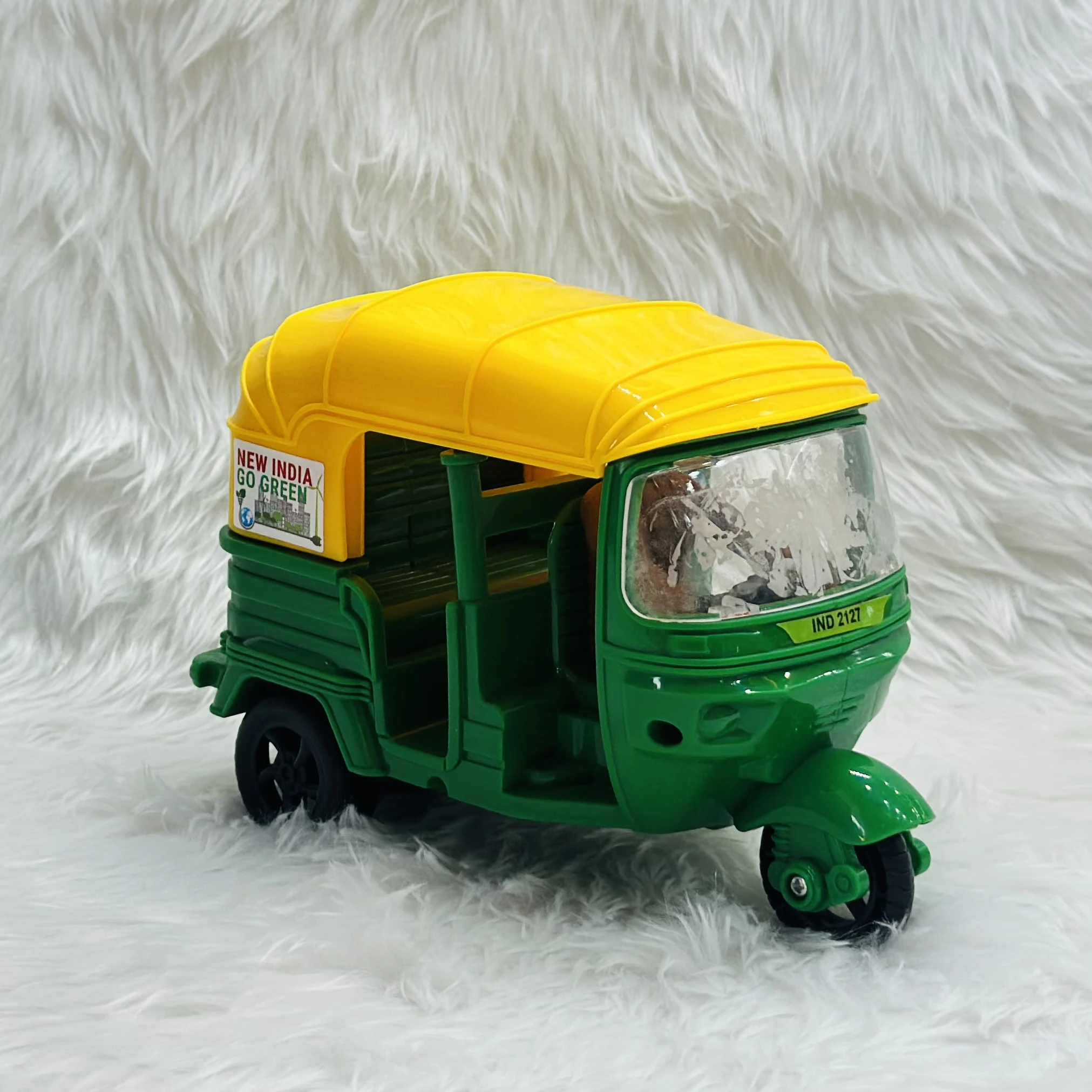 Yellow plastic toy auto rickshaw.