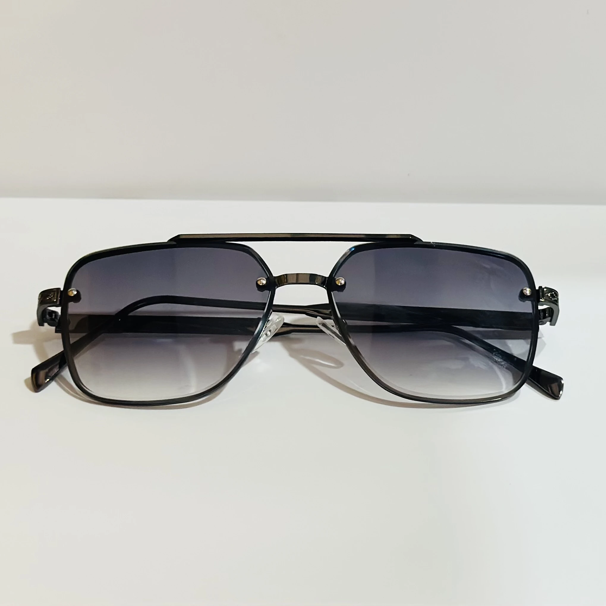 pair of black and grey gradient square sunglasses with a metal frame.
