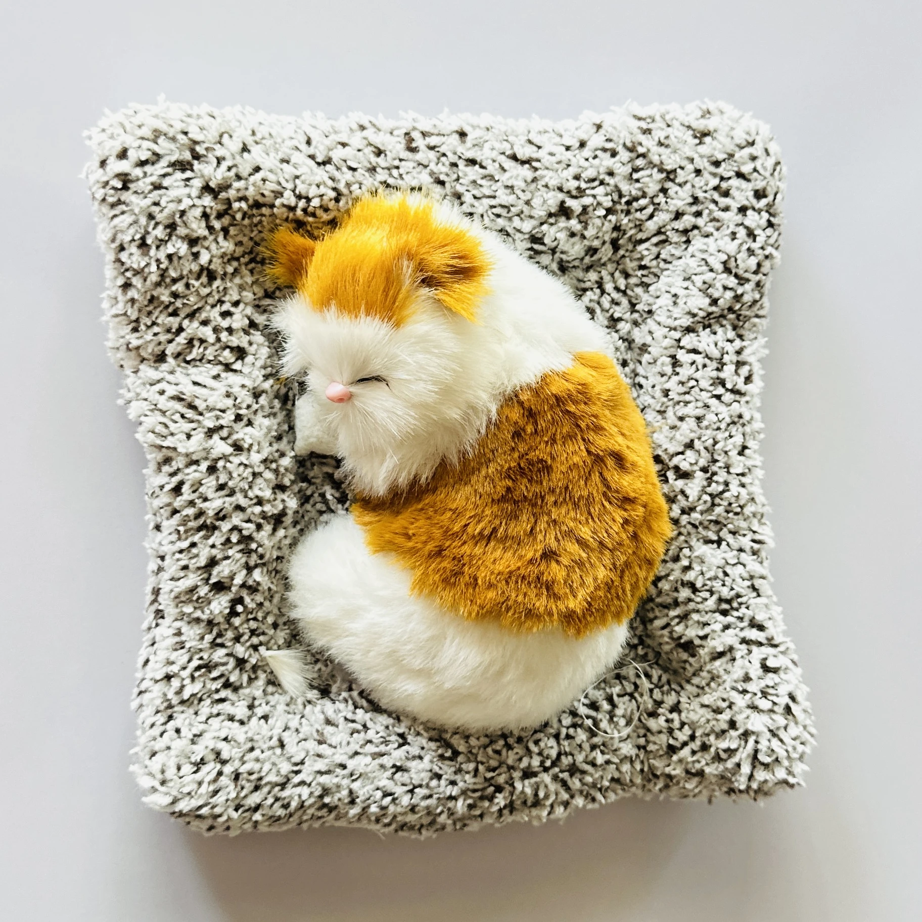 plush toy depicting a sleeping cat