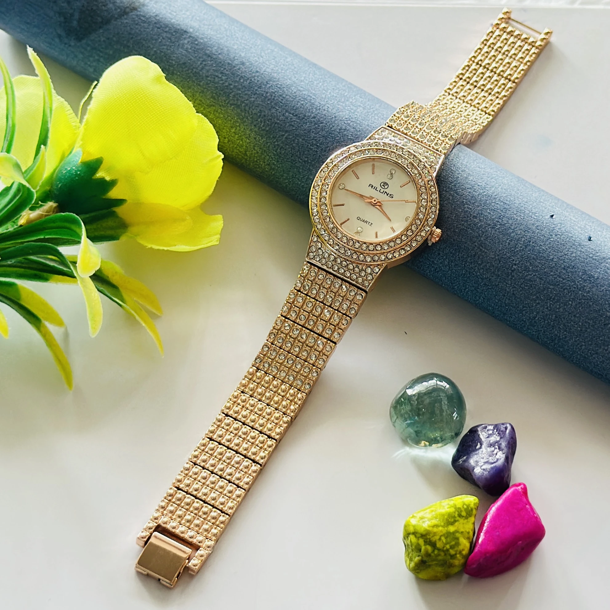 Gold toned Riluns analog quartz watch embellished with rhinestones