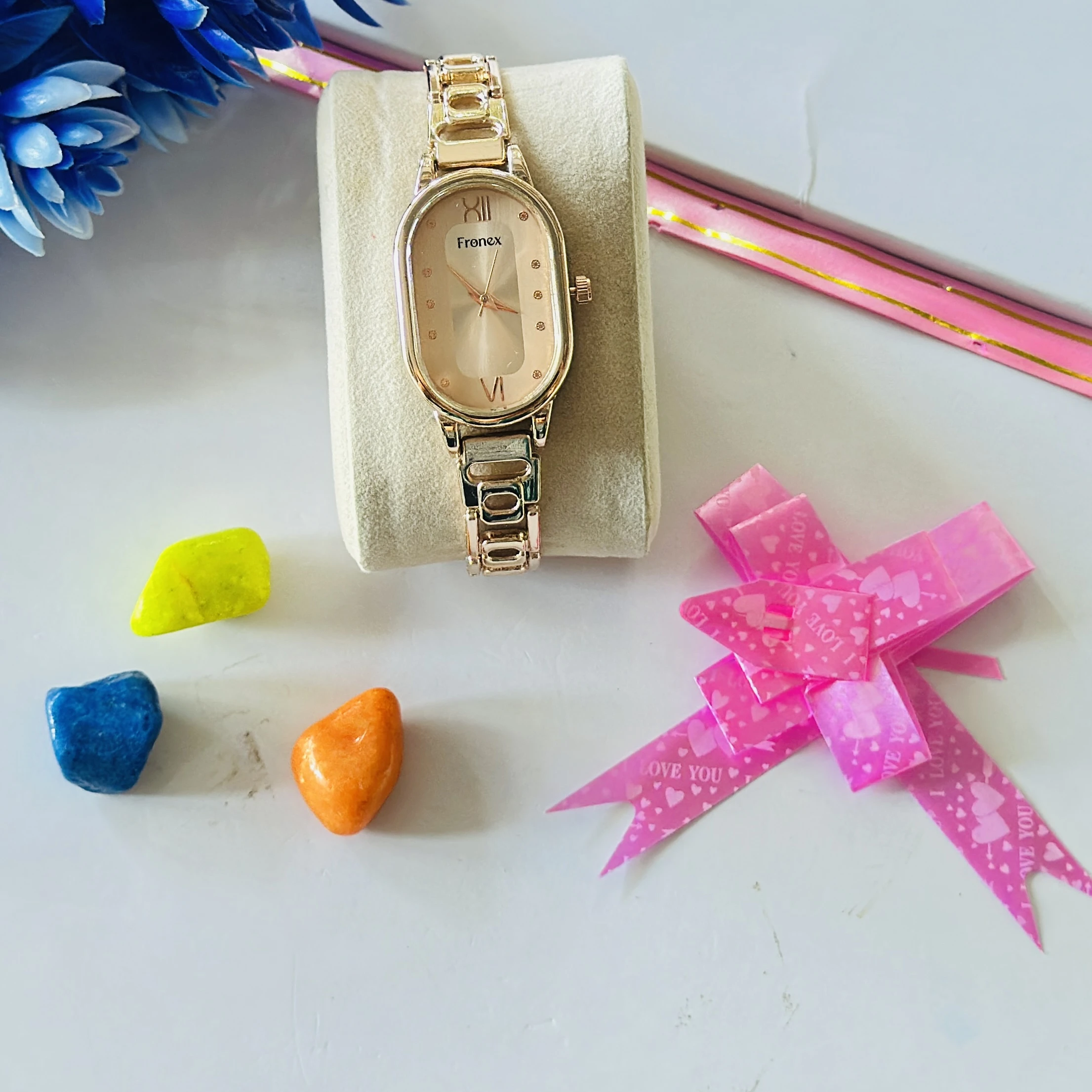 Frenex brand watch features a rose gold-toned oval dial and matching metal strap
