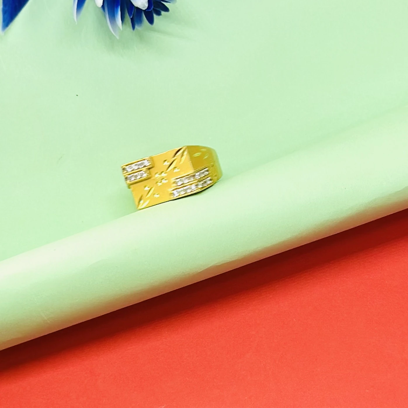 Gold plated men's ring made of brass with cubic zirconia stones.