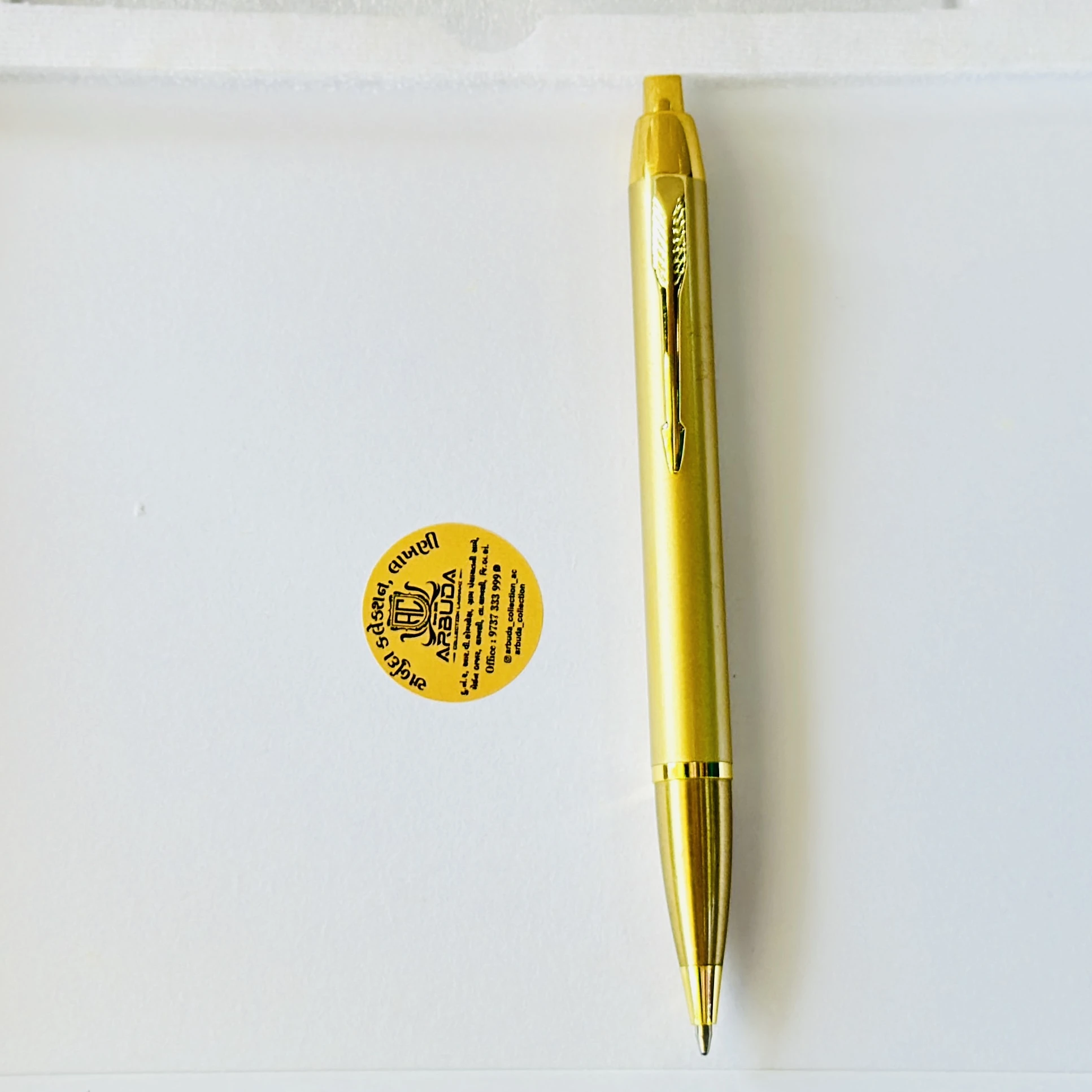 Gold colored metal click ballpoint pen.