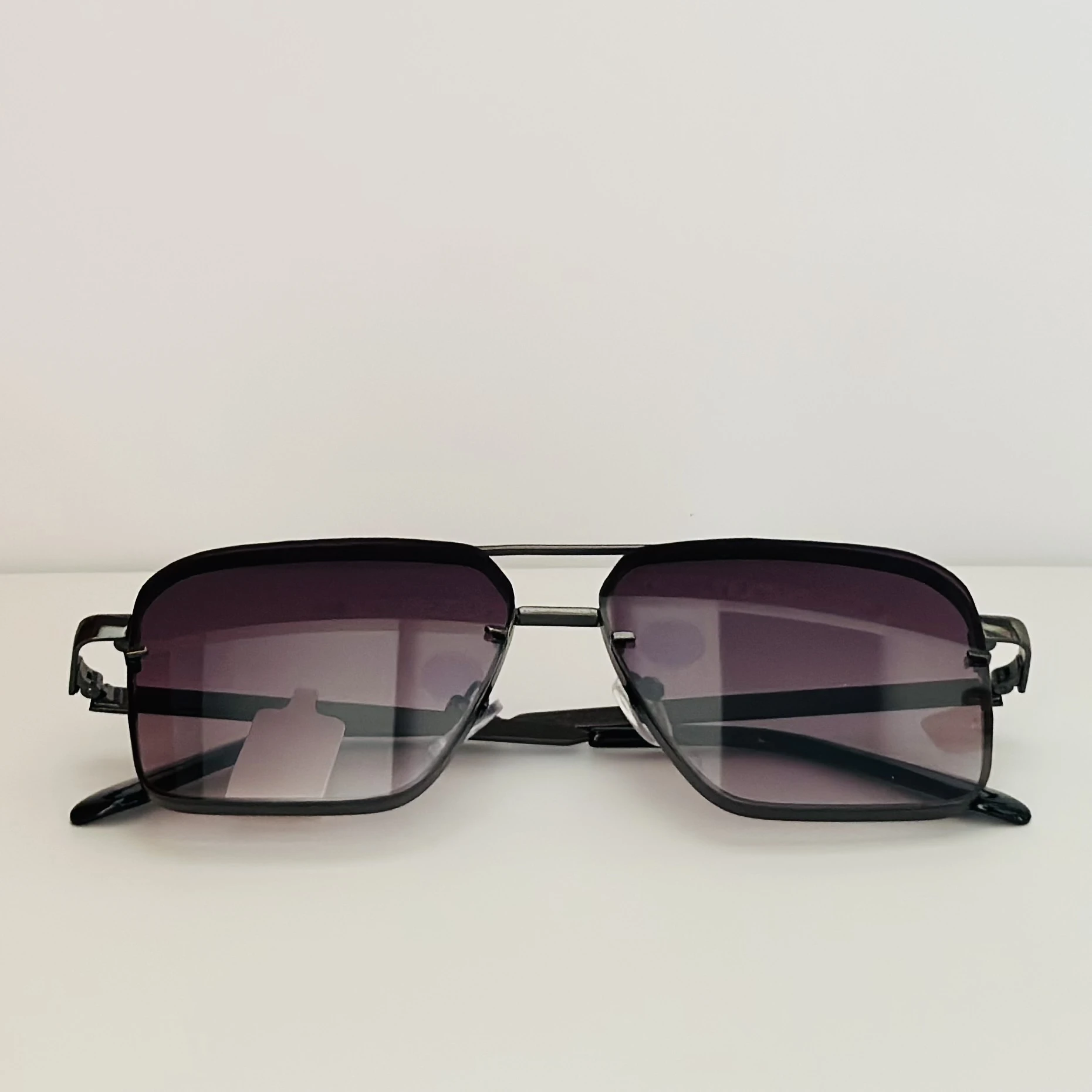 pair of square aviator gradient sunglasses with a black metal frame.