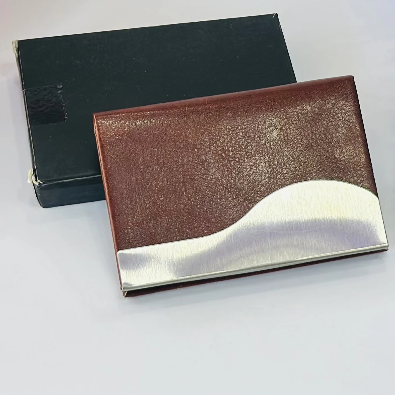 business card holder or card case, likely made of PU leather and stainless steel.