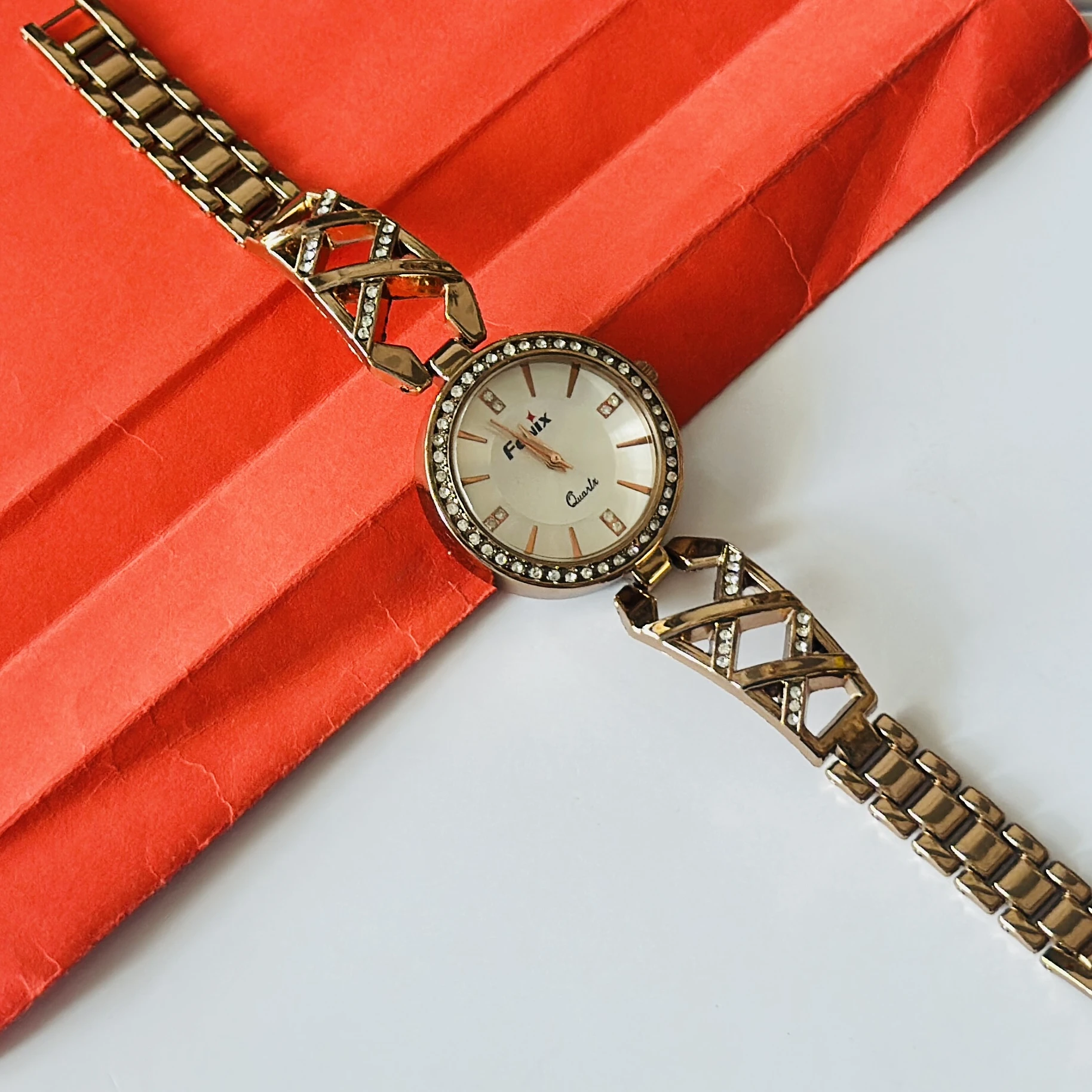Rose gold toned jewelry watches with studded dials and cutout bracelet straps