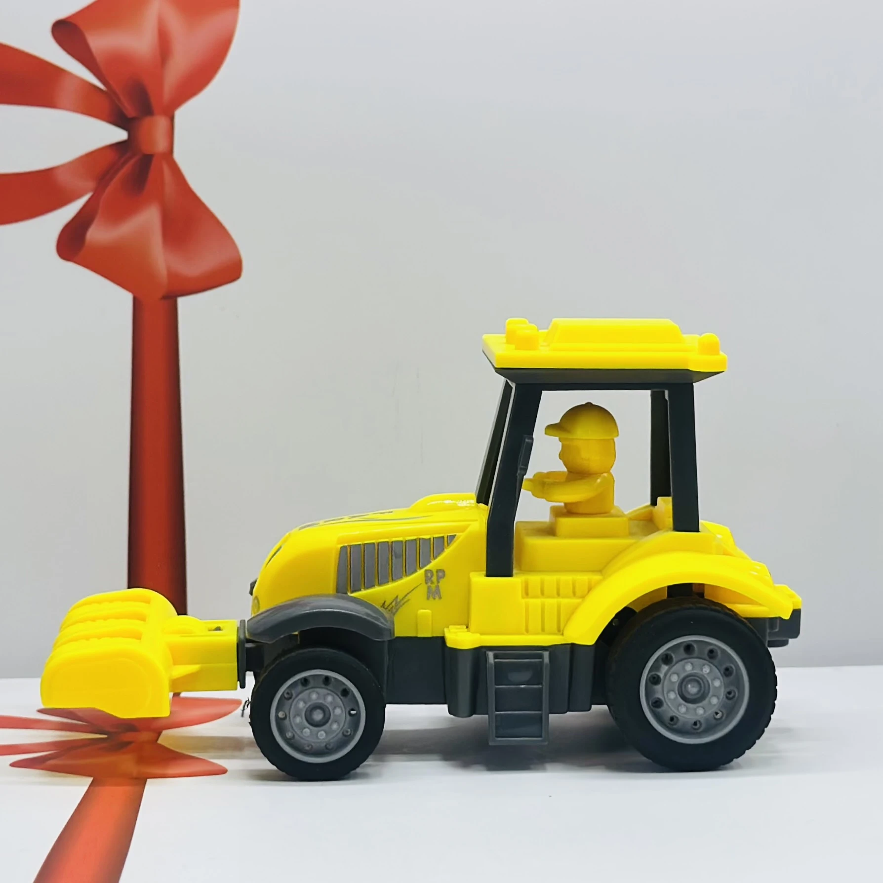 Yellow plastic toy tractor