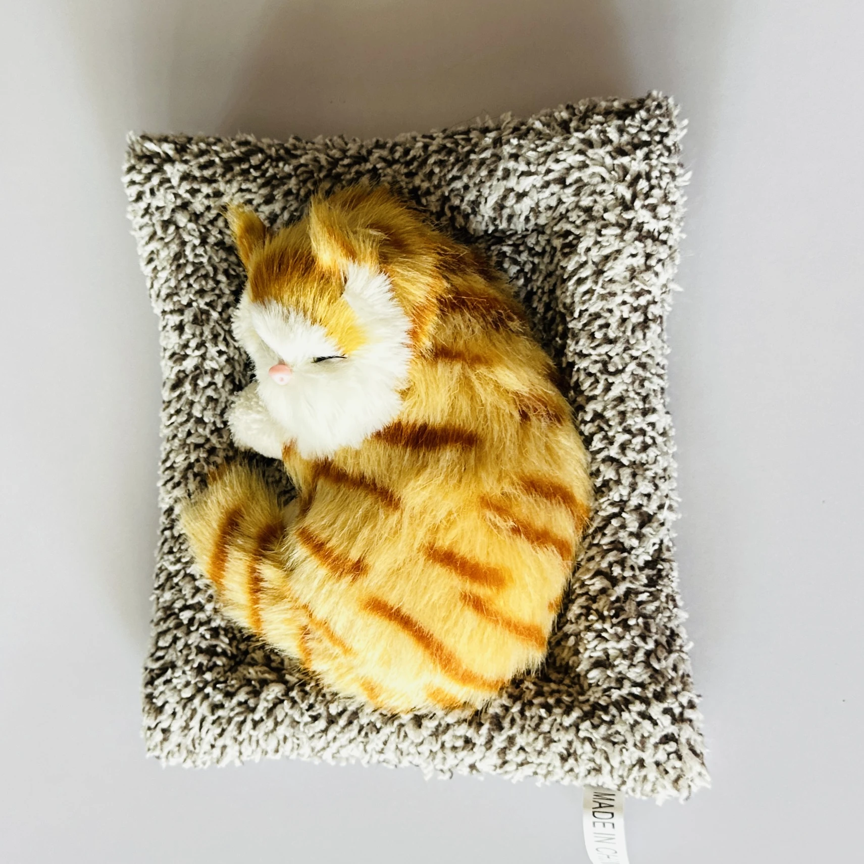 plush toy depicting a sleeping cat