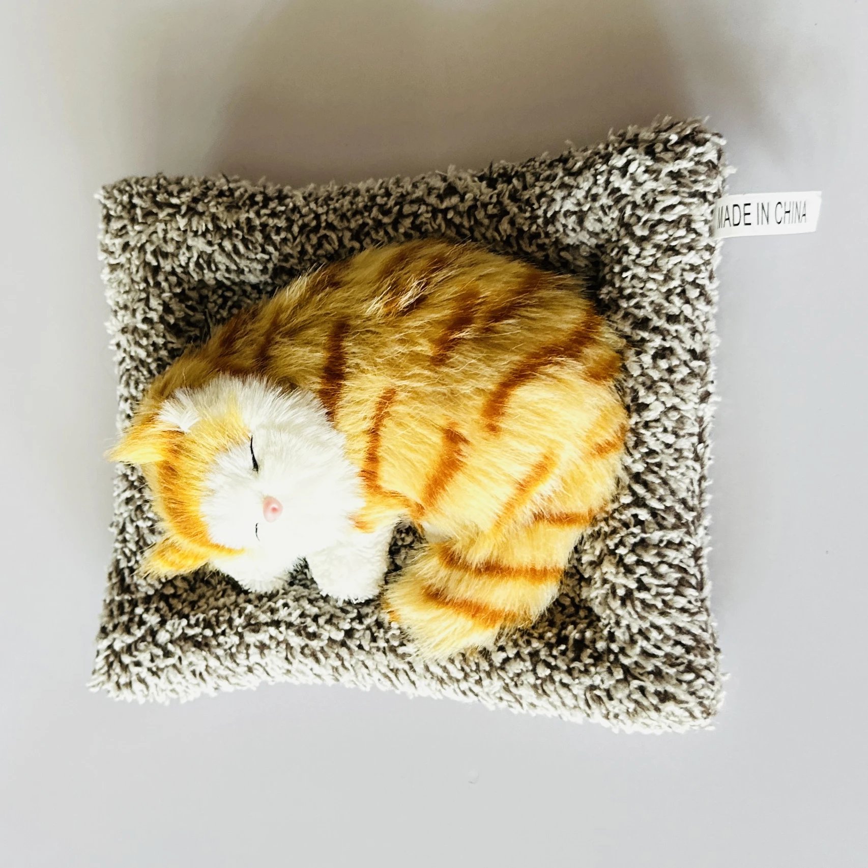 plush toy depicting a sleeping cat