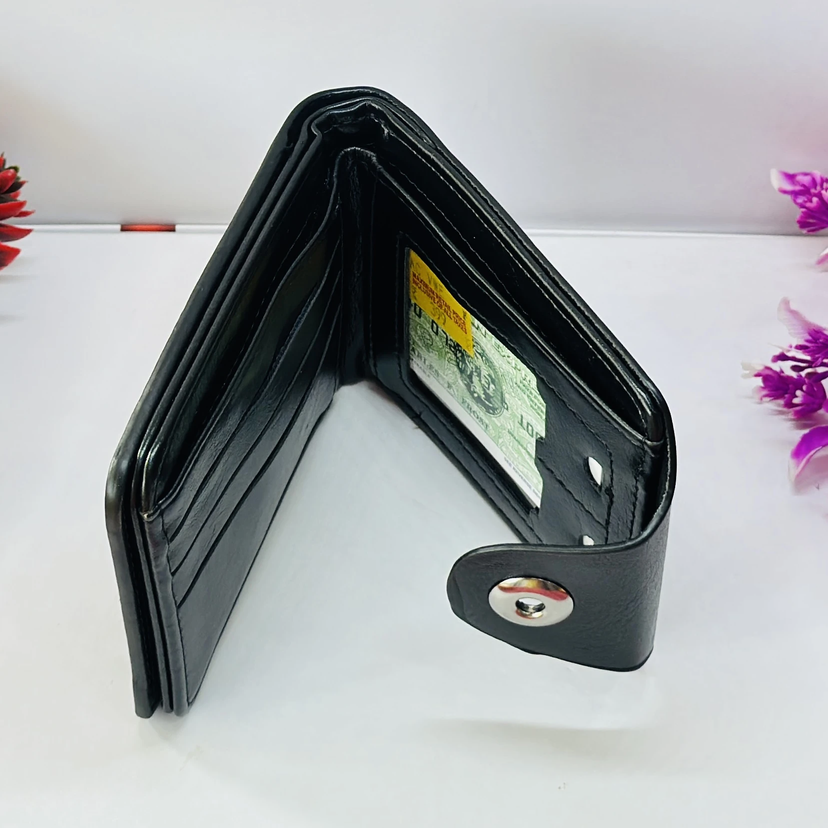 Black "Balisi" men's leather wallet with a button closure.