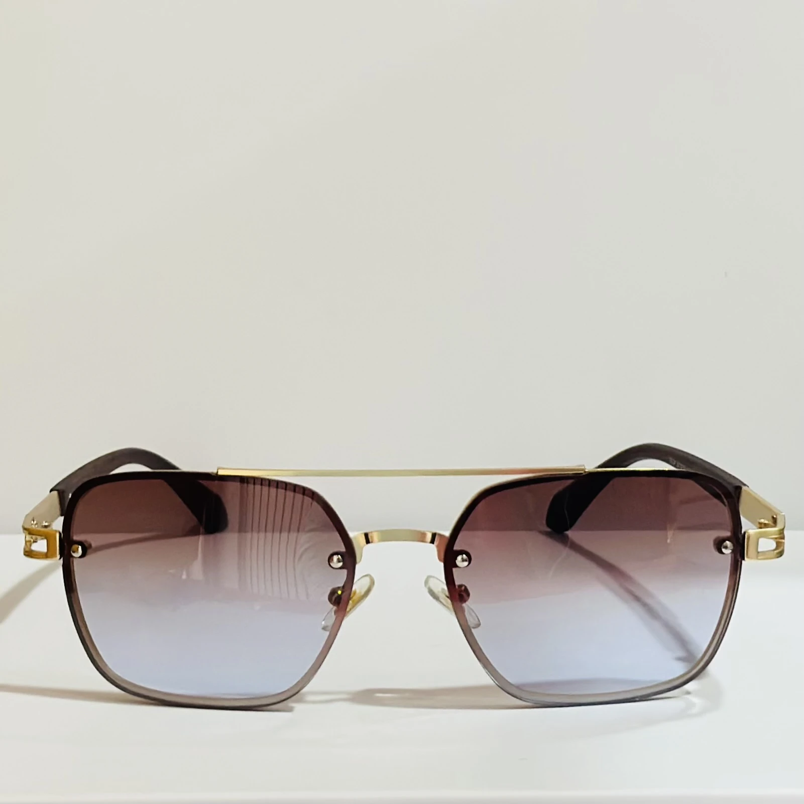 pair of Maybach square gradient sunglasses with a gold-tone frame.