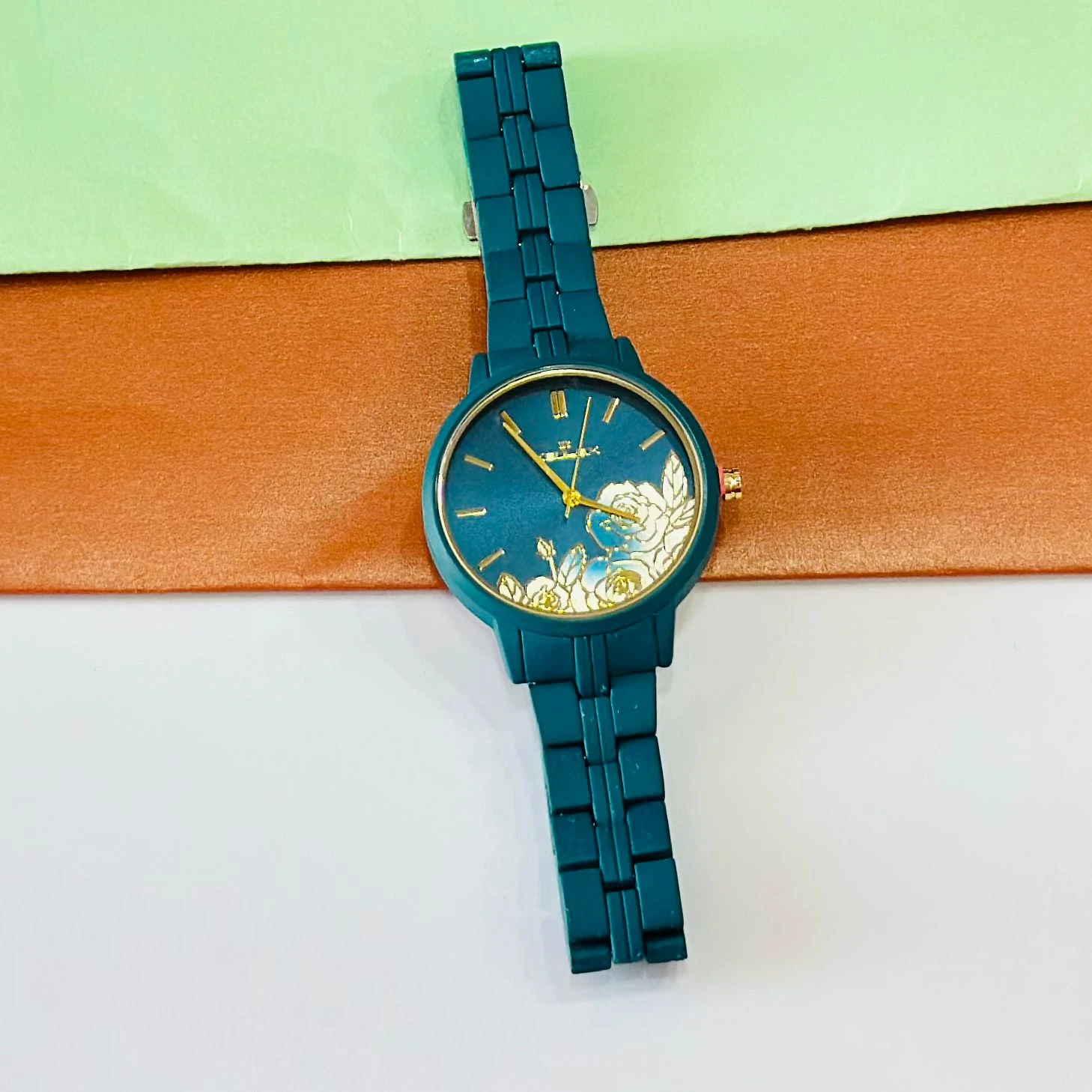 TEAL BY CHUMBAK Tulip Garden Quilted Analog Watch for Women in a teal blue hue.