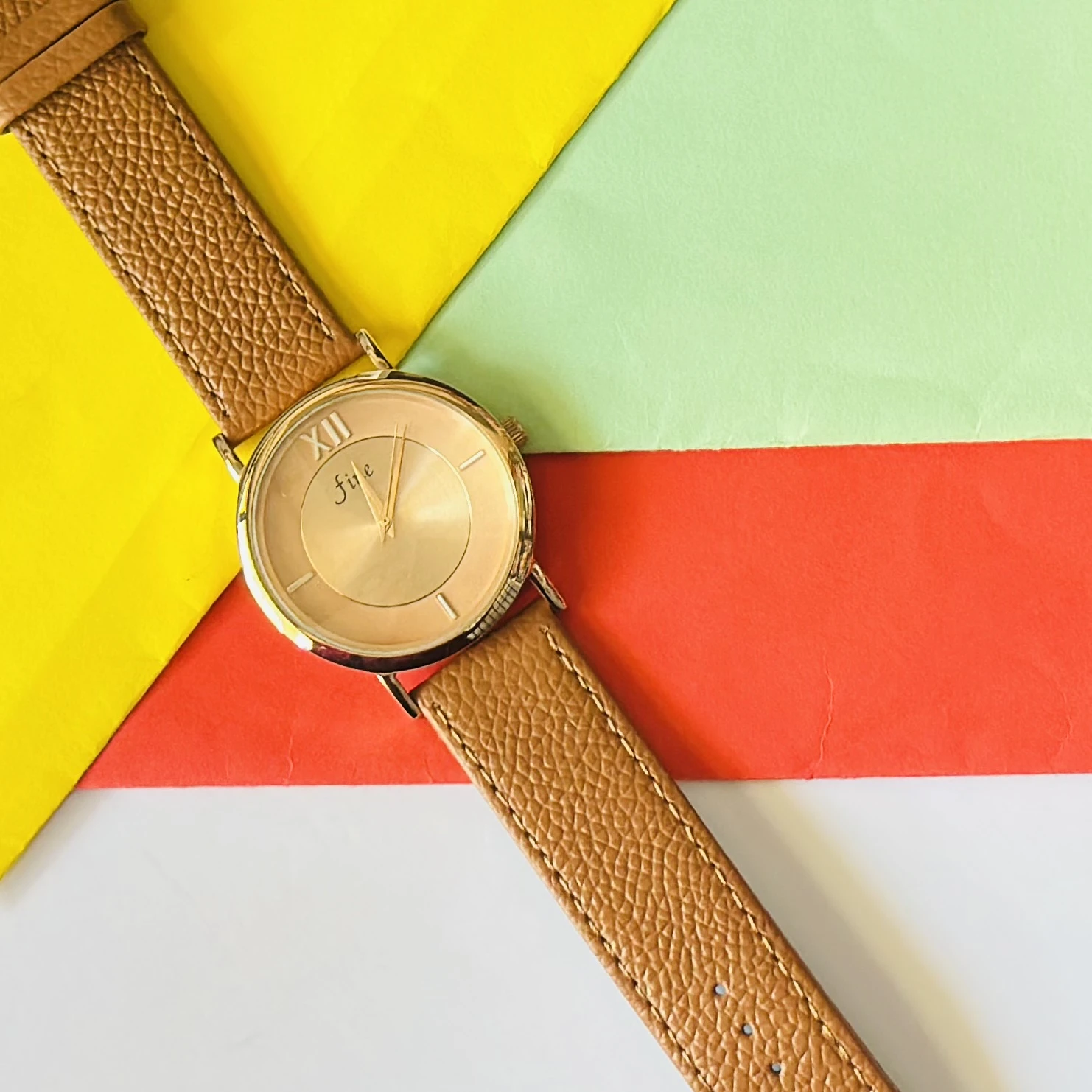 Jule Sun-Kissed watch with a tan faux leather strap and gold-toned details.