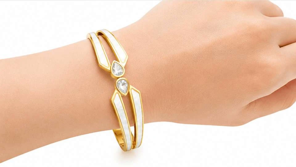 Gold tone hinged bangle bracelet